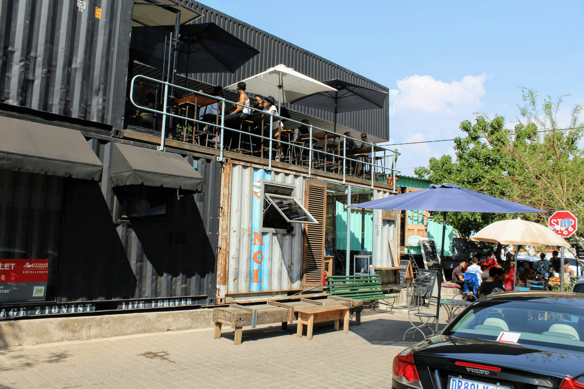 container coffee shop exterior bustling with happy customers