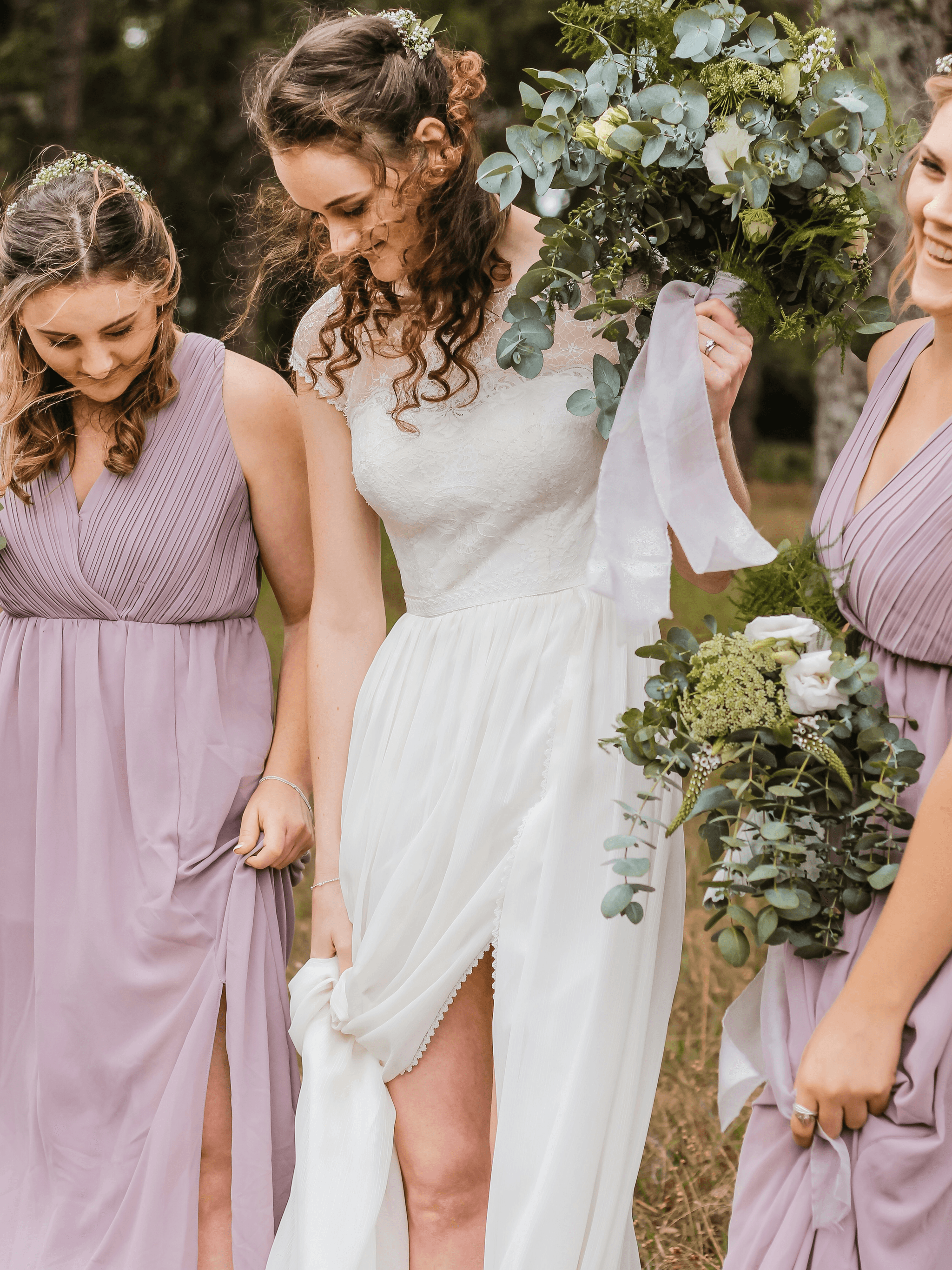 Bridesmaids wearing affordable wedding jewelry during a beautiful outdoor ceremony.