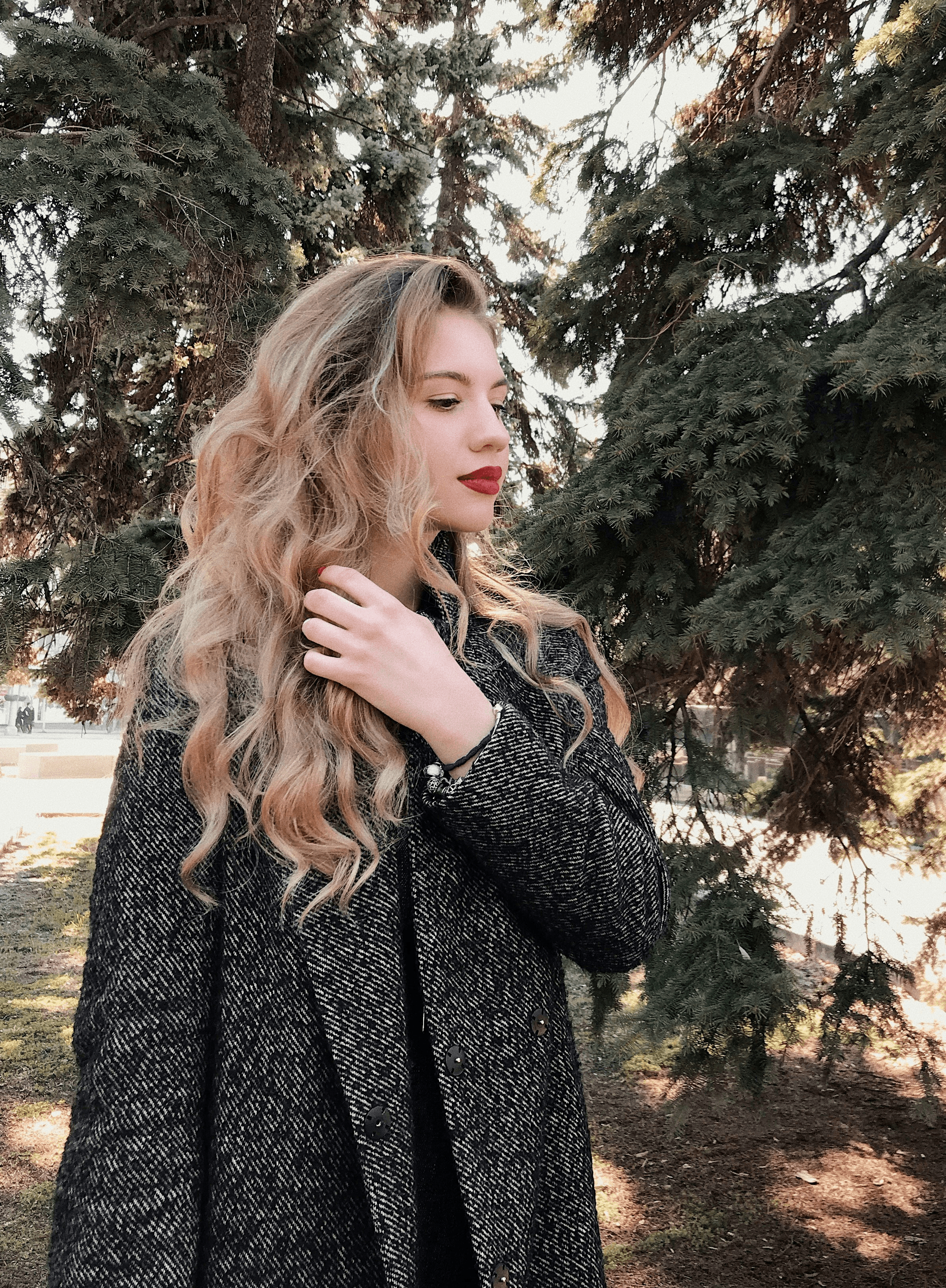 woman showcasing quality hair extensions in natural sunlight