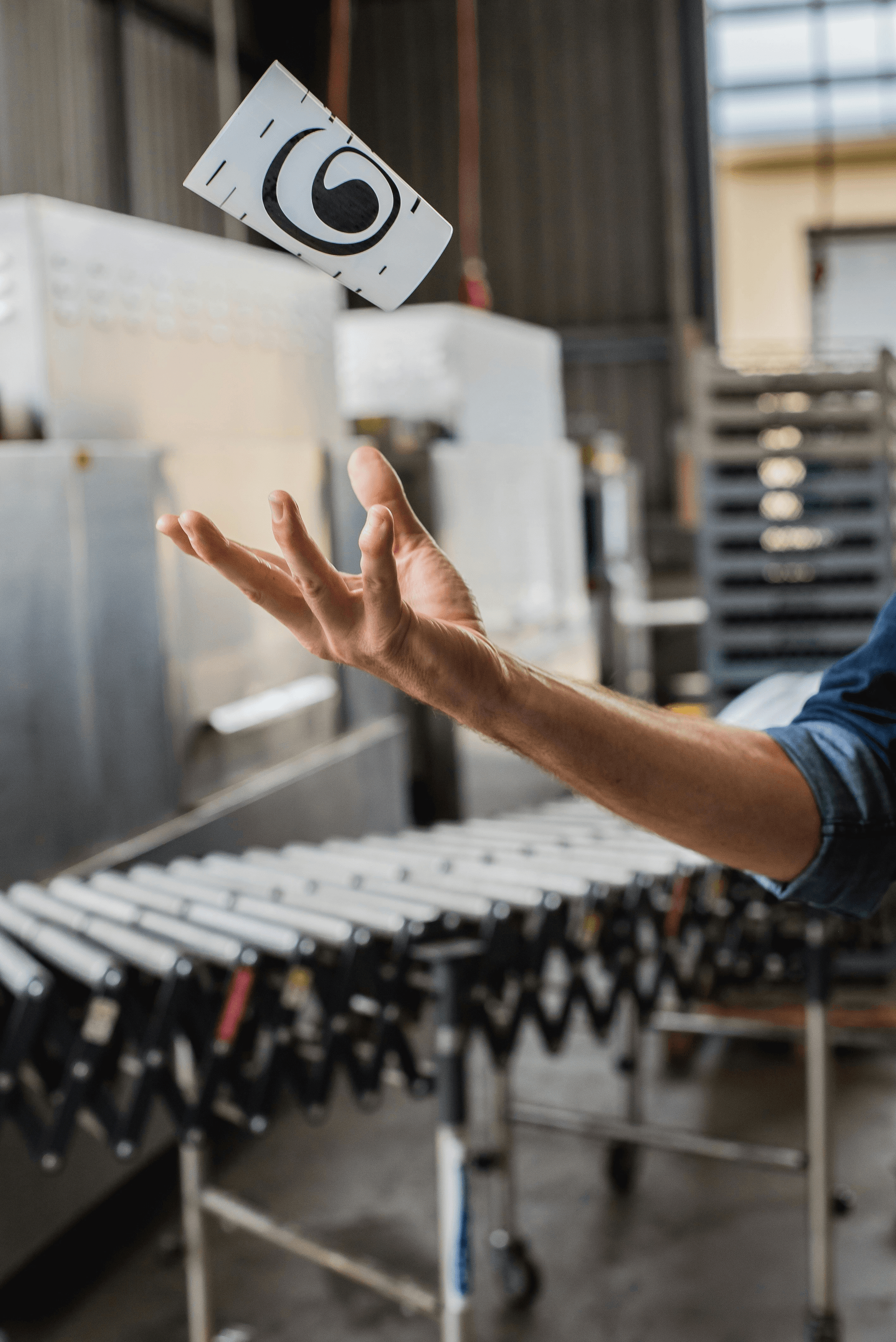 Ethical manufacturing worker smiling on eco-friendly production line