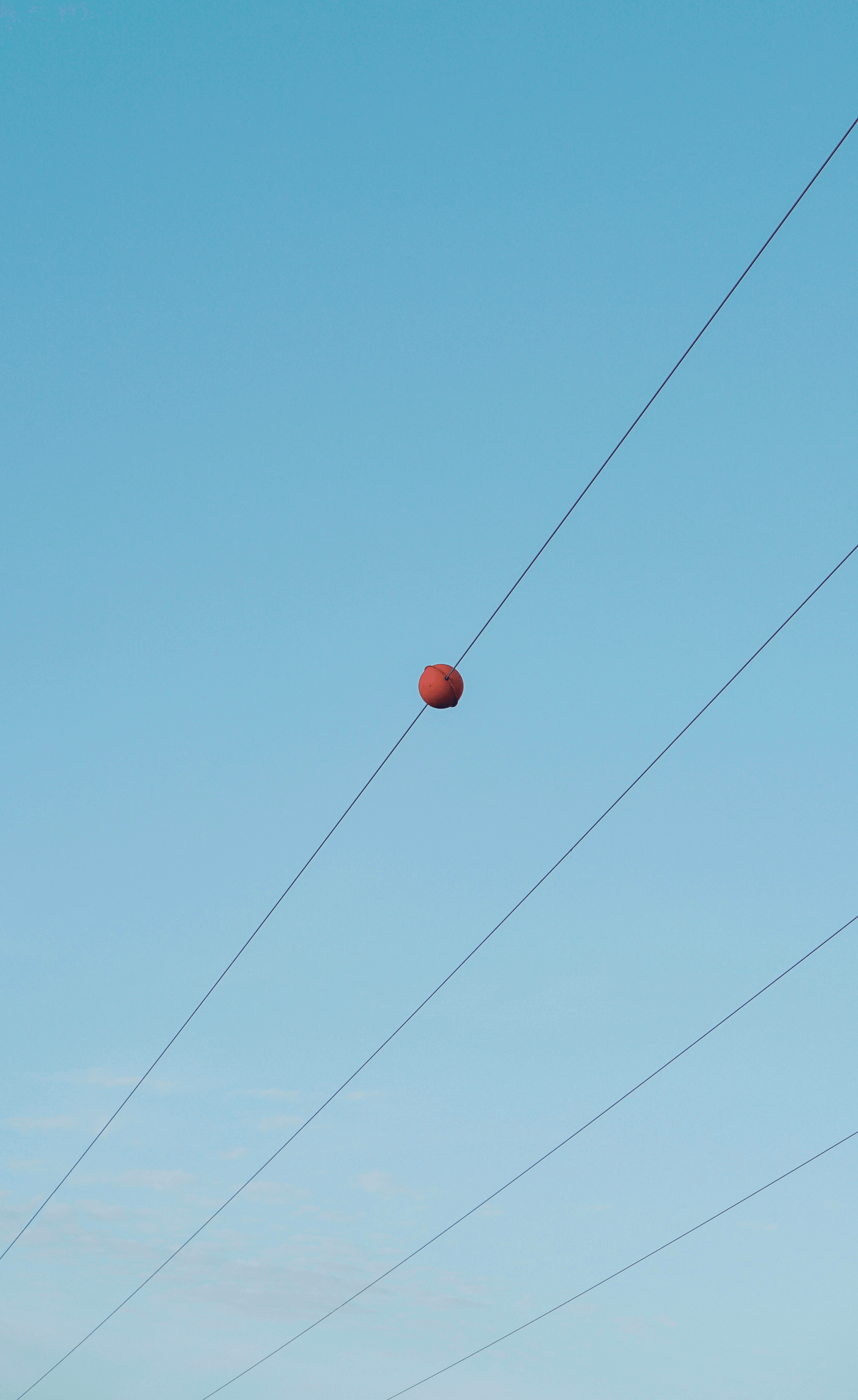 Colorful marker ball installation enhancing power line visibility.