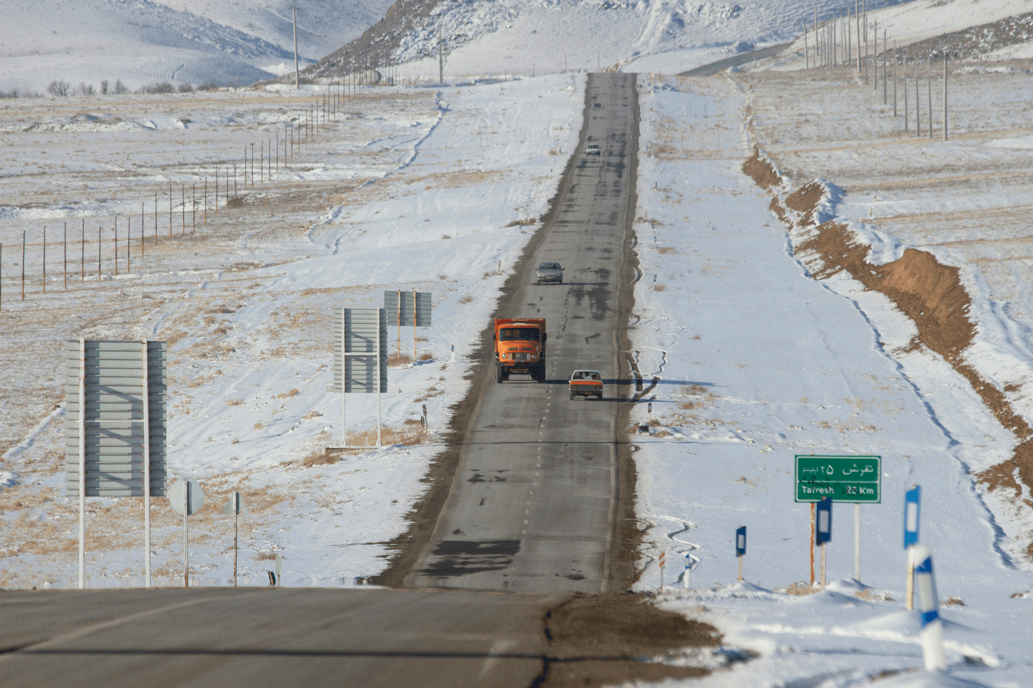 truck mounted snow blower at work clearing snowy highway