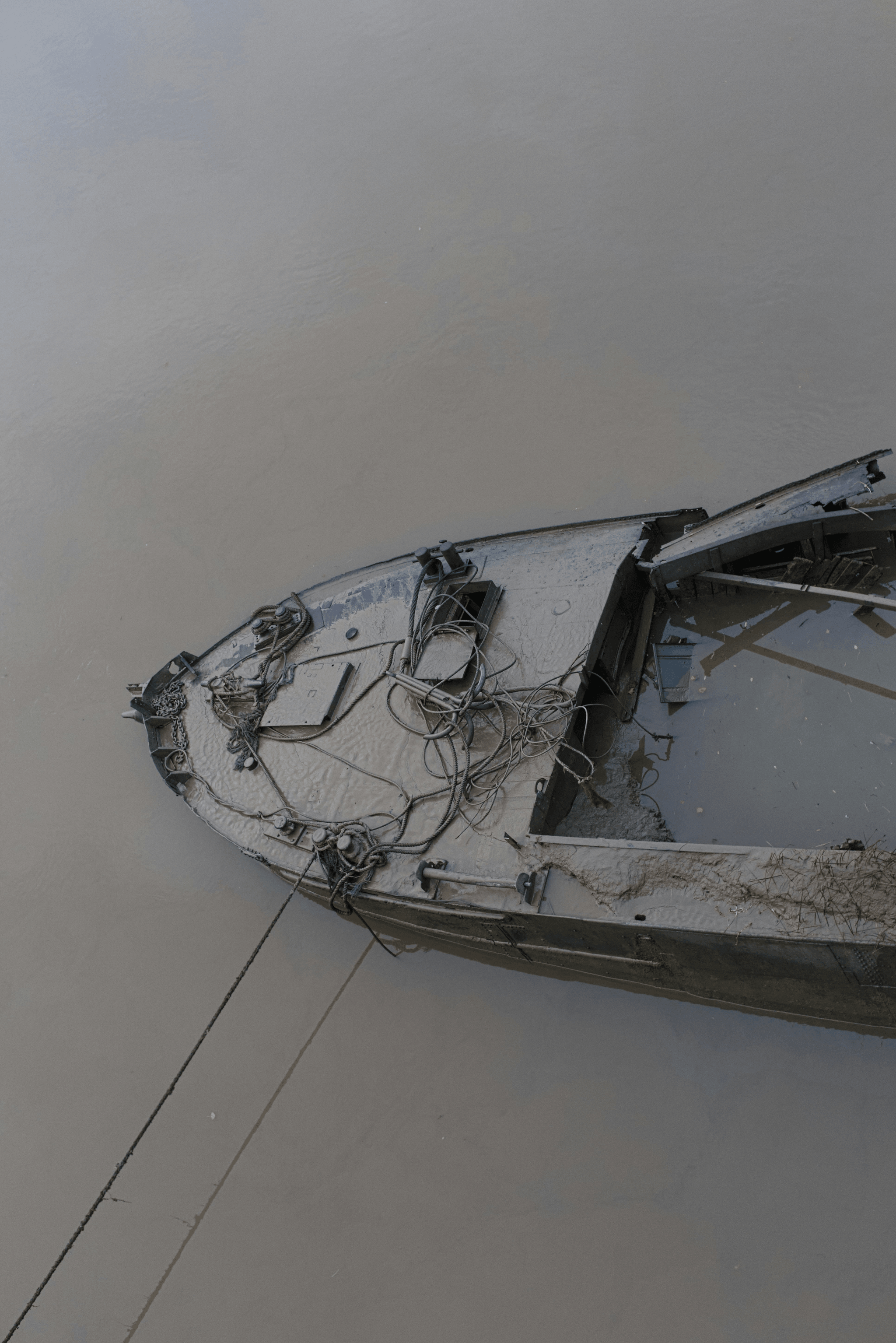 Person inspecting small aluminum boat's hull for damages