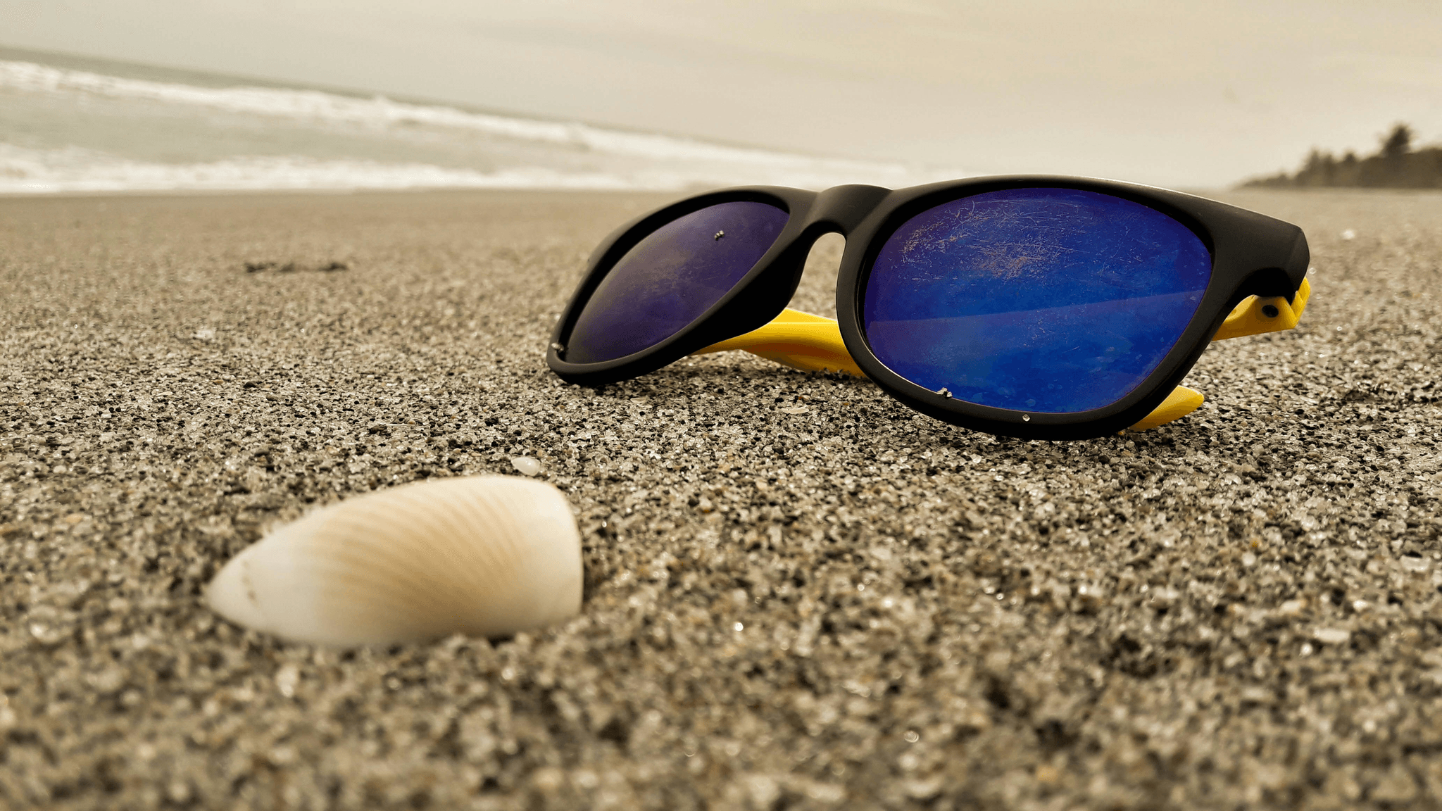 sunglass material lens options displayed on a beach towel