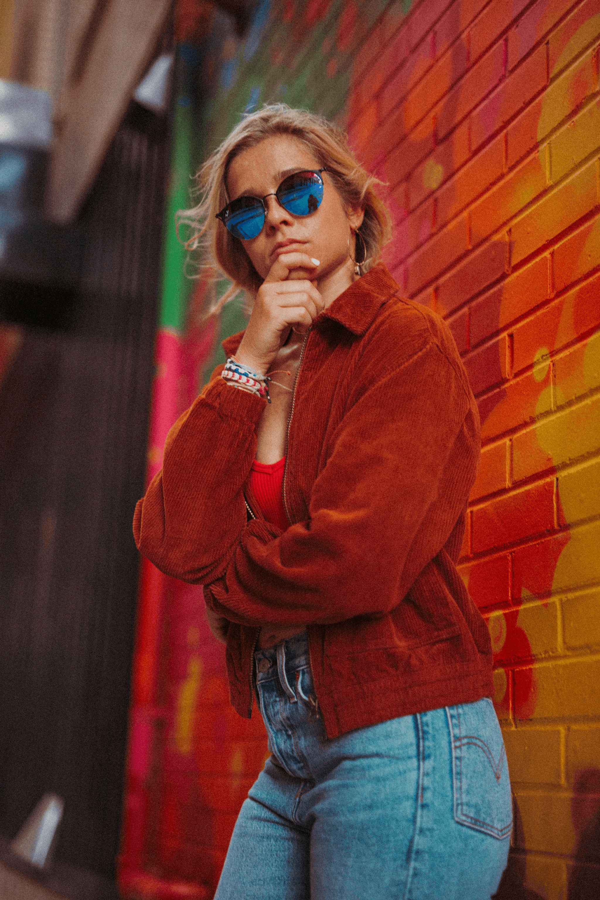 Woman showcasing popular eyeglass frames in retro round style.