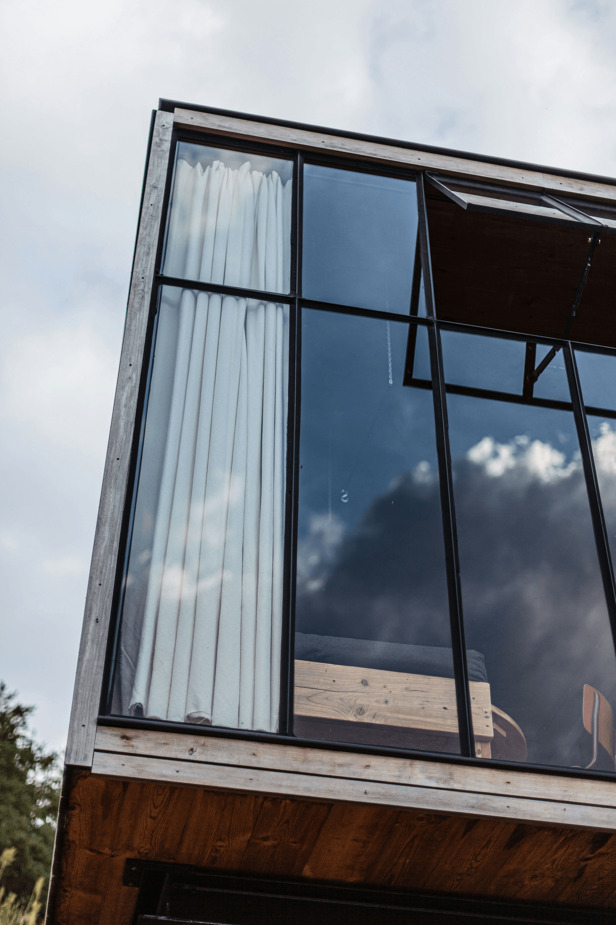 Modern steel container home surrounded by greenery