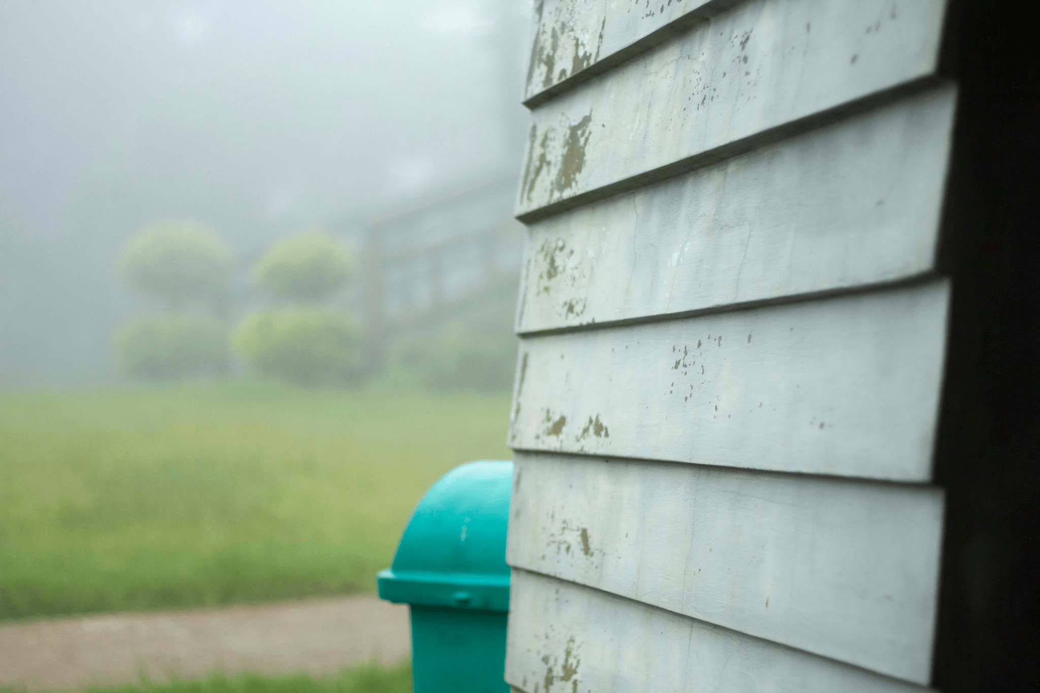Rain barrels collecting rainwater in a prefabricated container house.