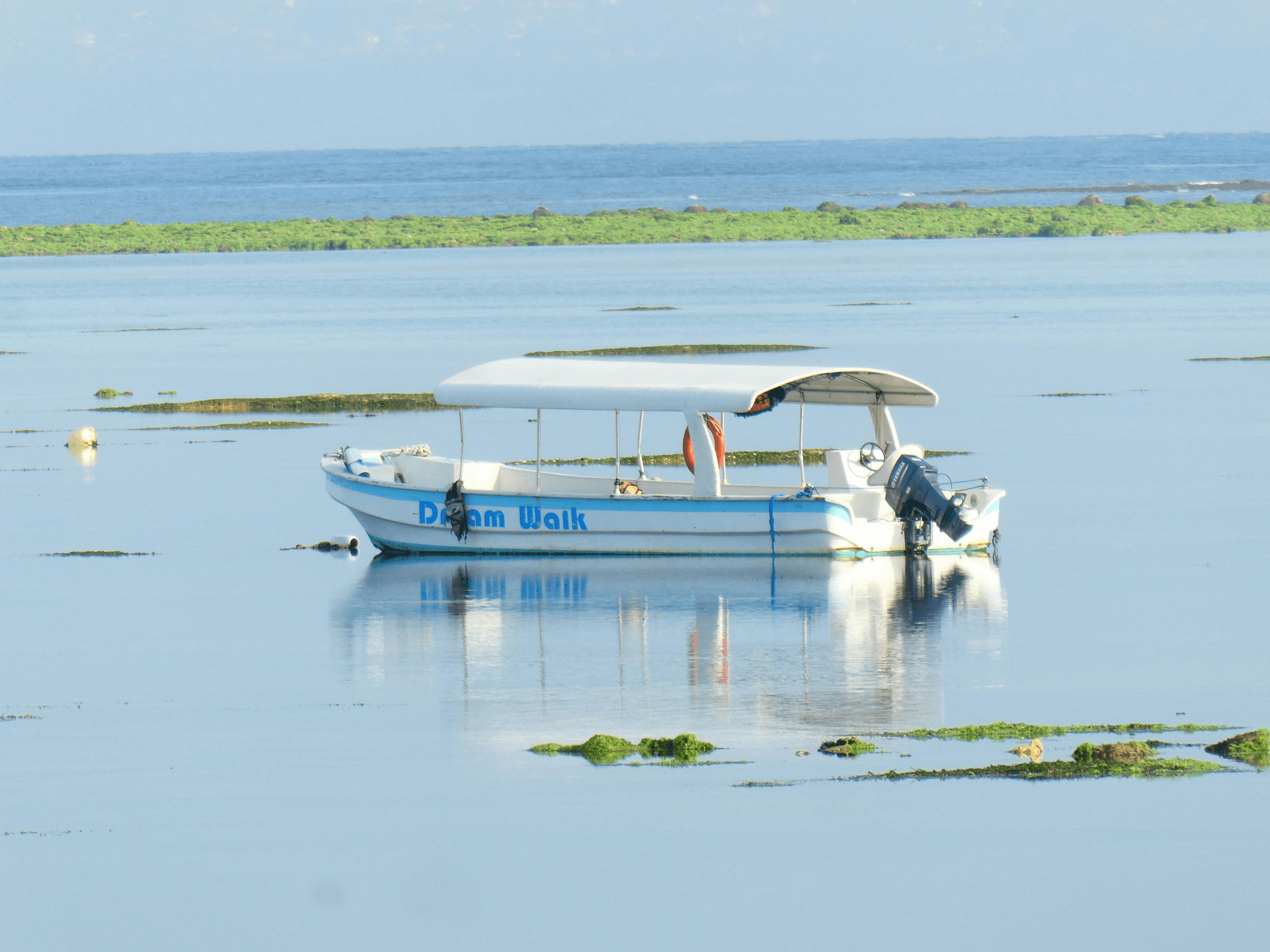flat bottom aluminum boat on calm waters