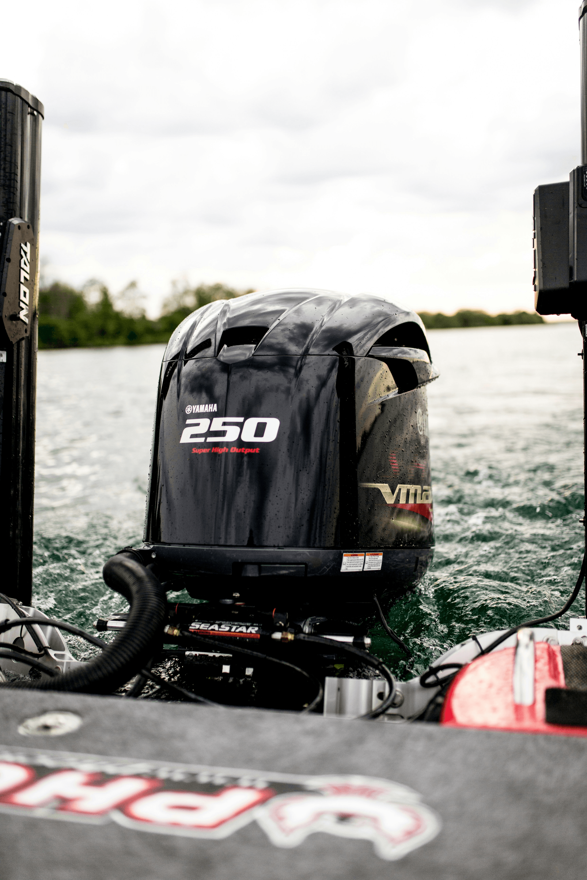 Outboard motor attached to a white 16 foot aluminum boat