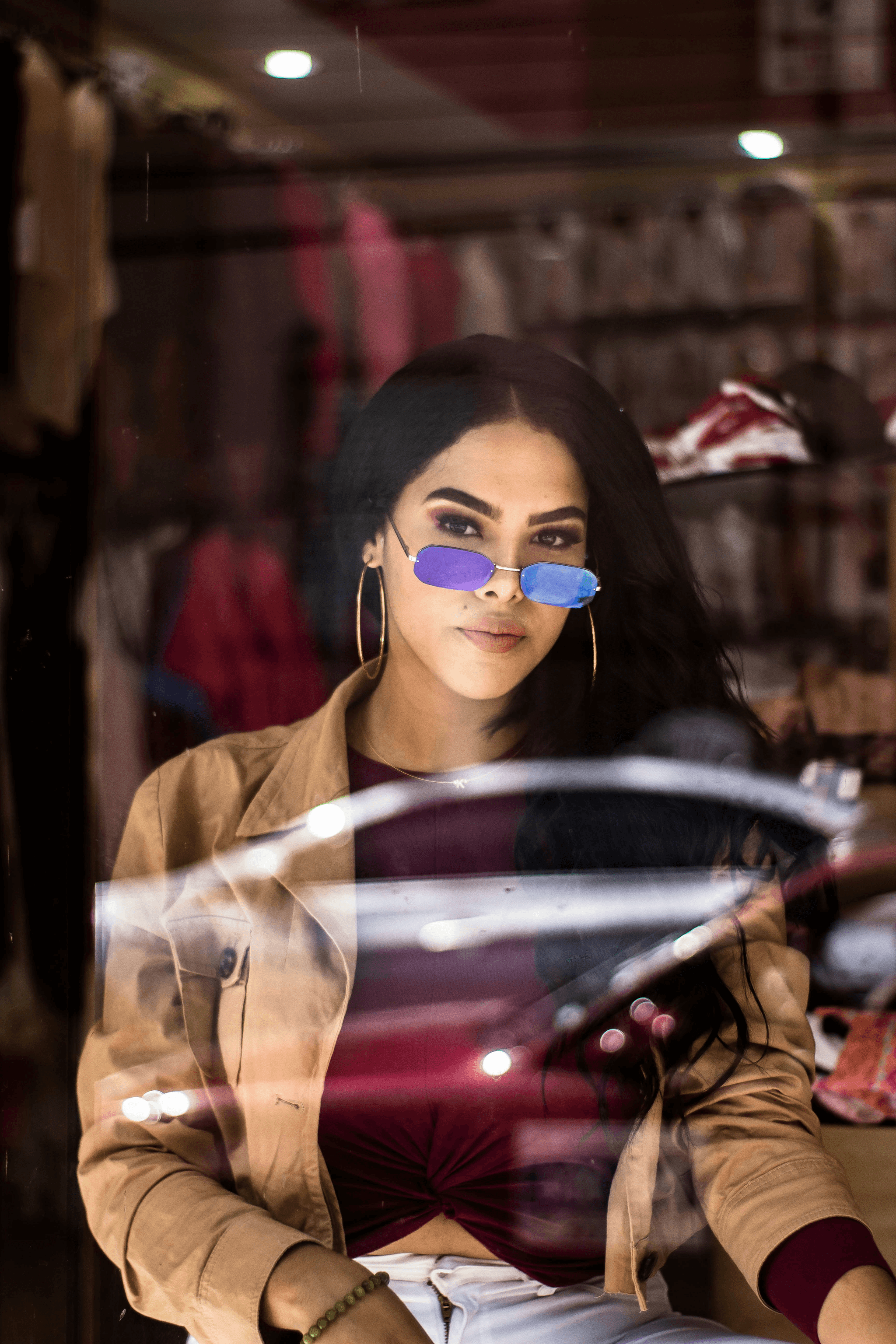 Choosing stylish prescription sunglasses bifocal in a trendy store.