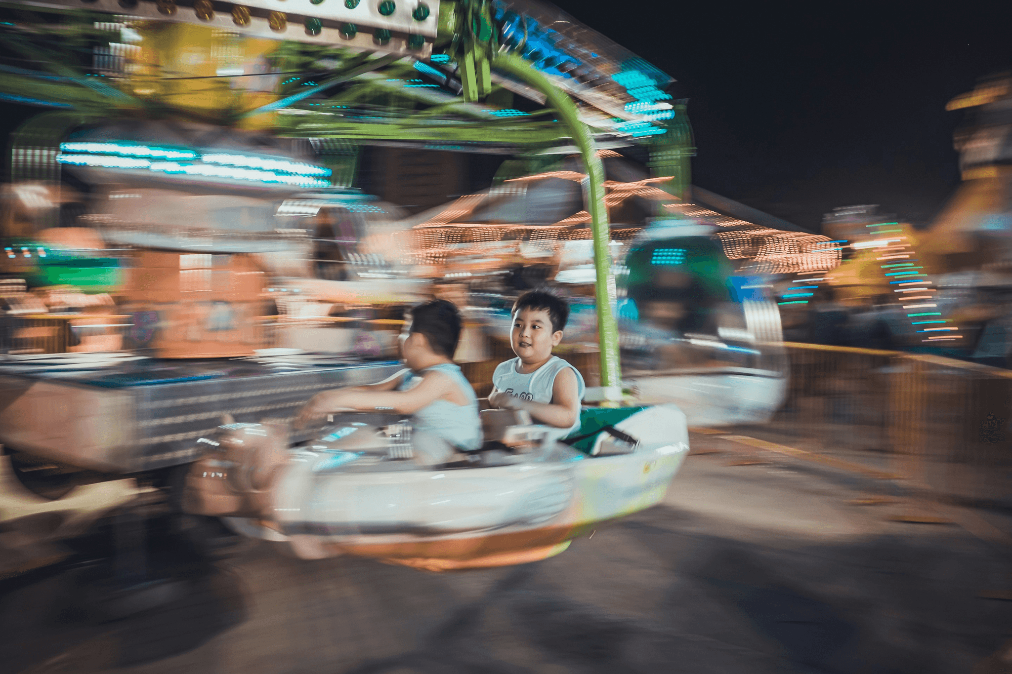 Excited children enjoying a carousel ride at the family-friendly fair in Canton