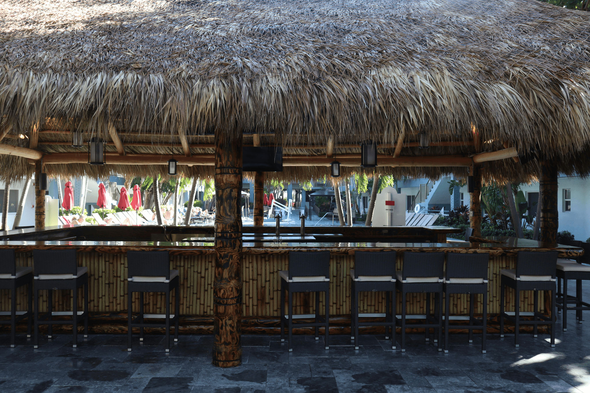 Outdoor portable bar at tropical luau party.