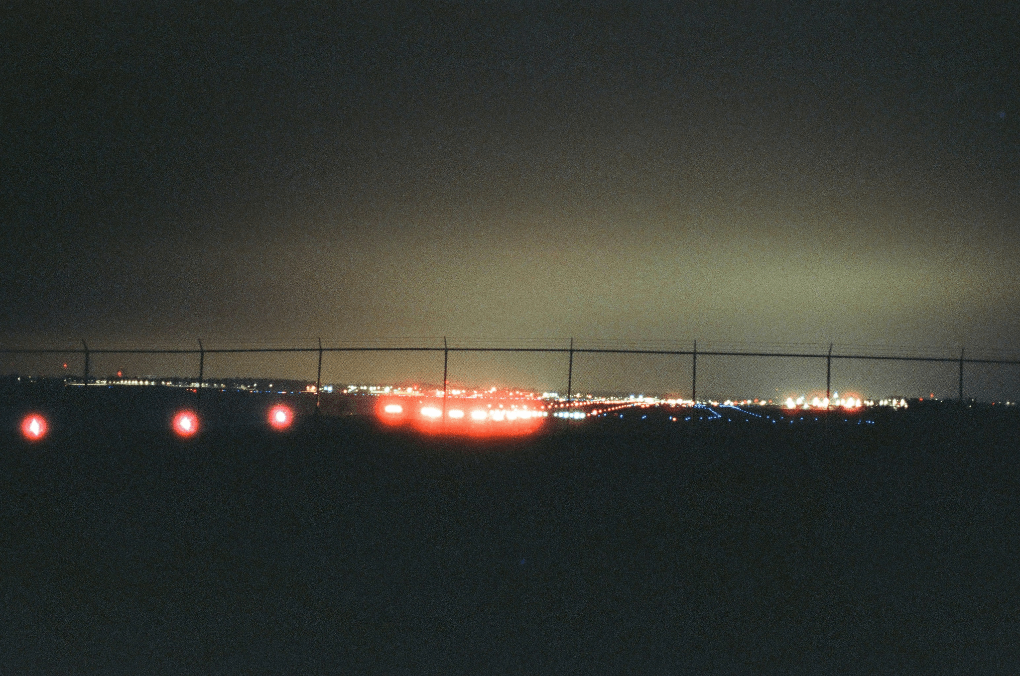 runway intersection lights and light intensity tester in use at airport.
