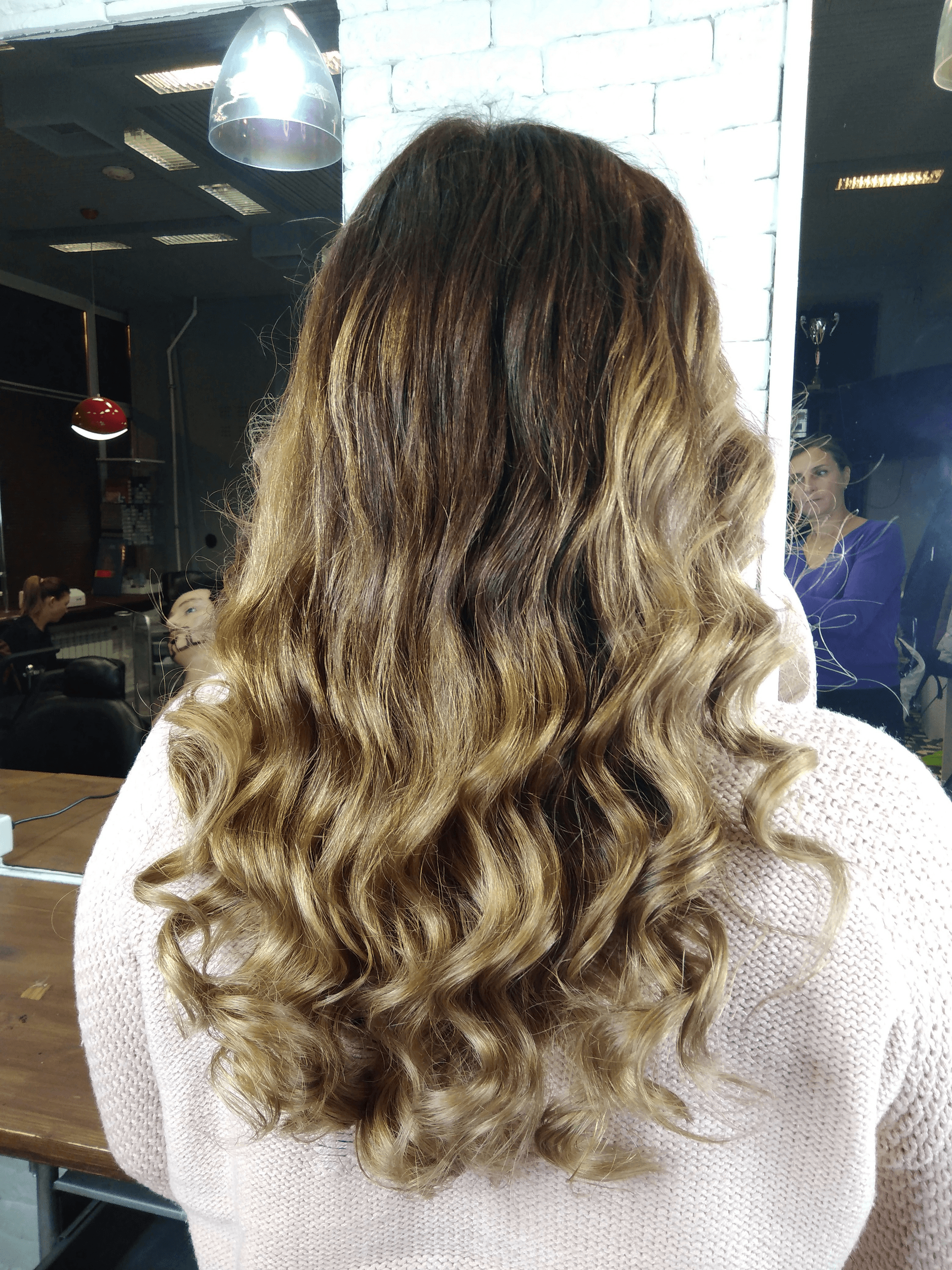 Beautiful balyage curly hair extensions showcasing vibrant color blending