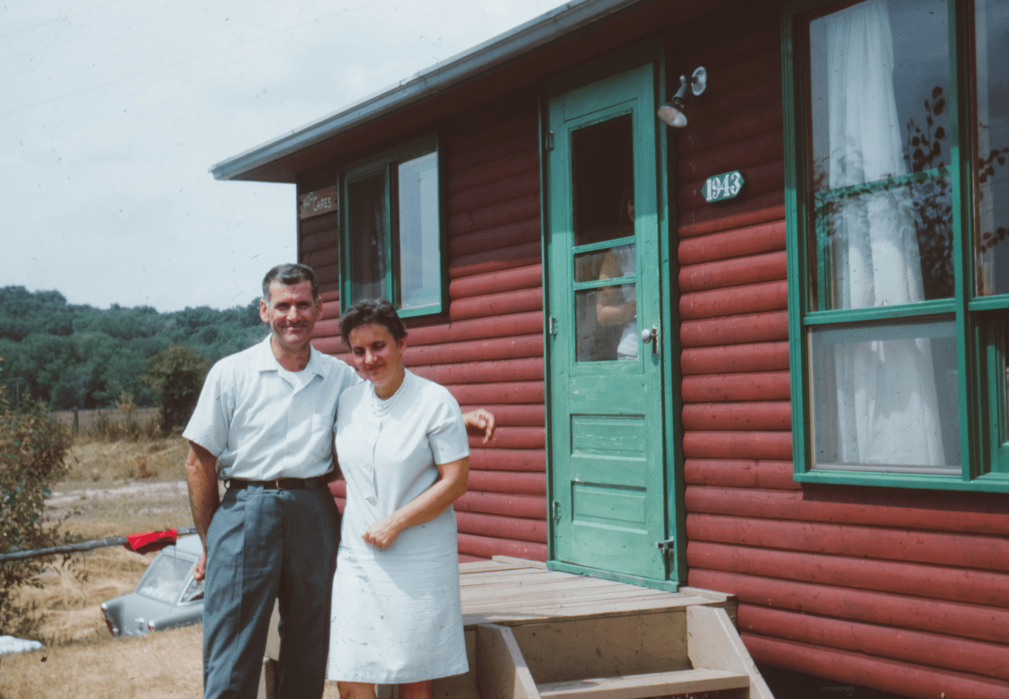 Happy family enjoying life in their cozy log cabin mobile home