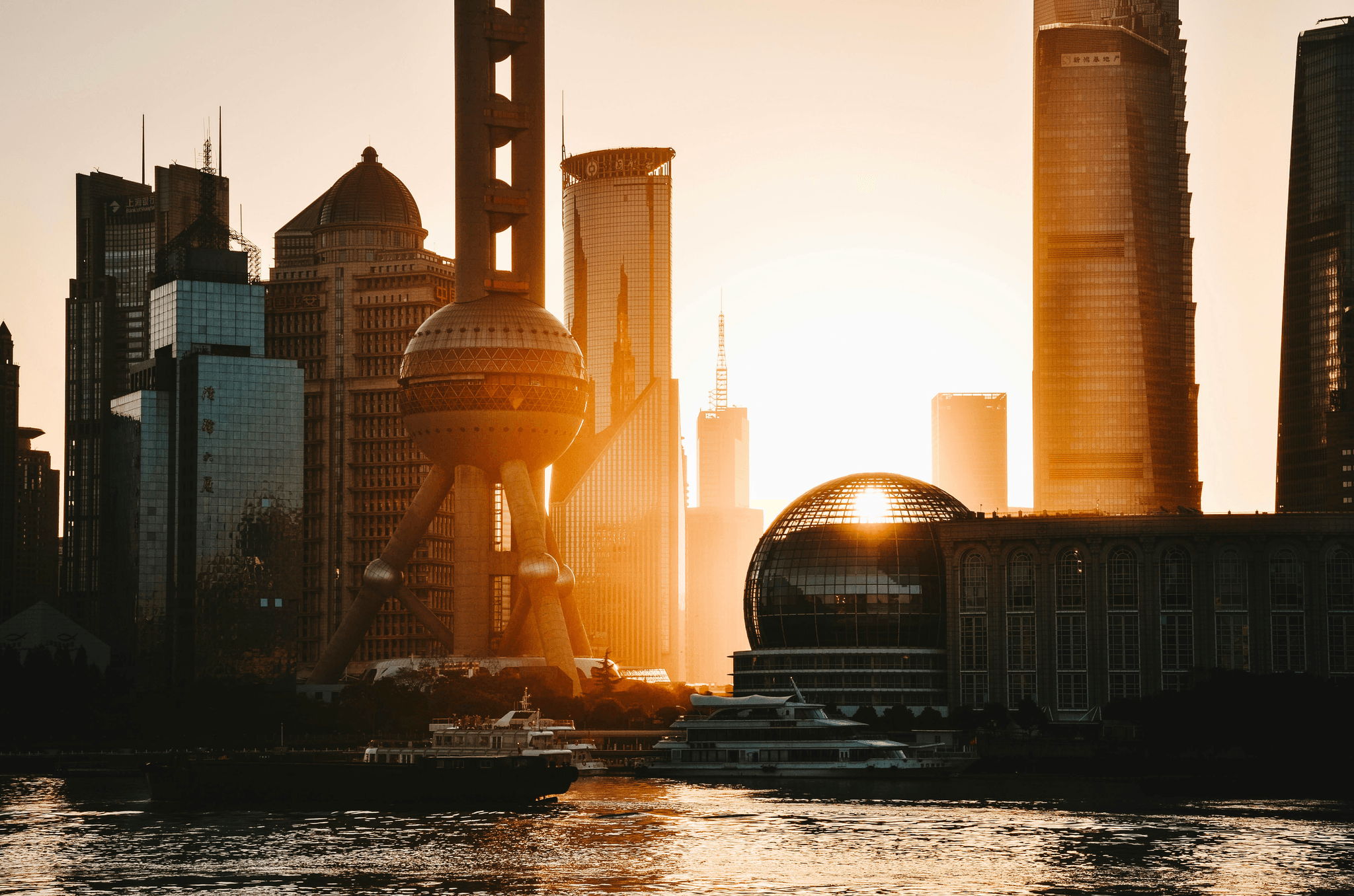 Shanghai skyline at sunset with modern buildings along Huangpu River