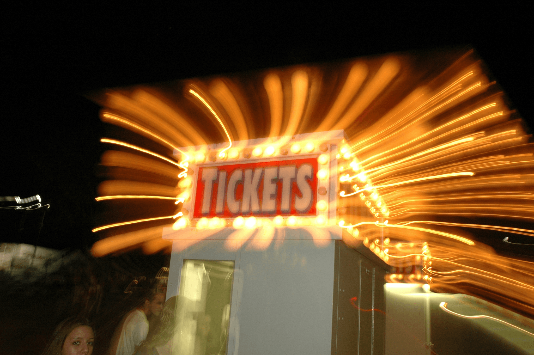 Customized portable ticket booth attracting attention at an outdoor event.