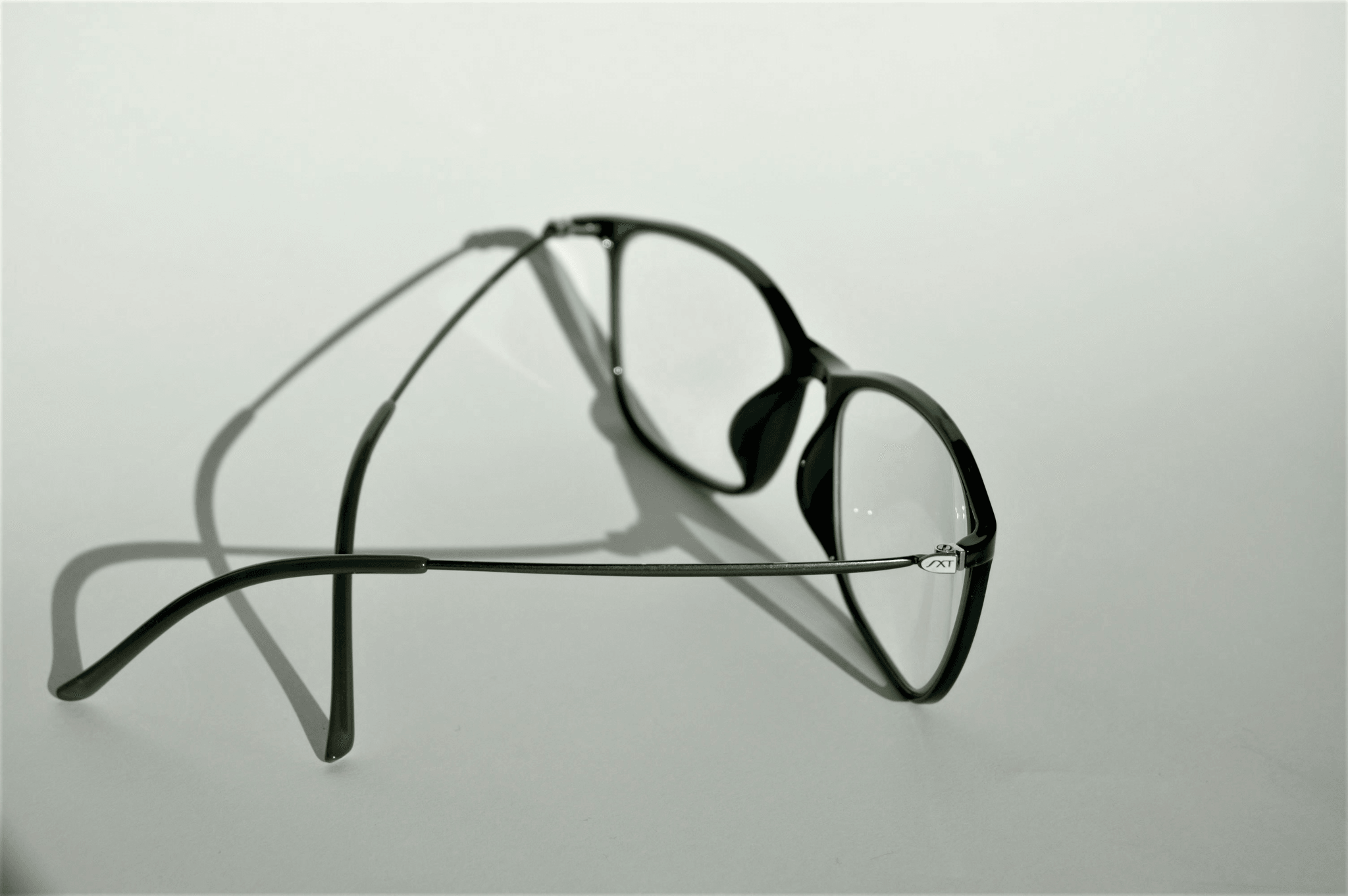 Stylish plastic frames with adjustable nose pads showcased.