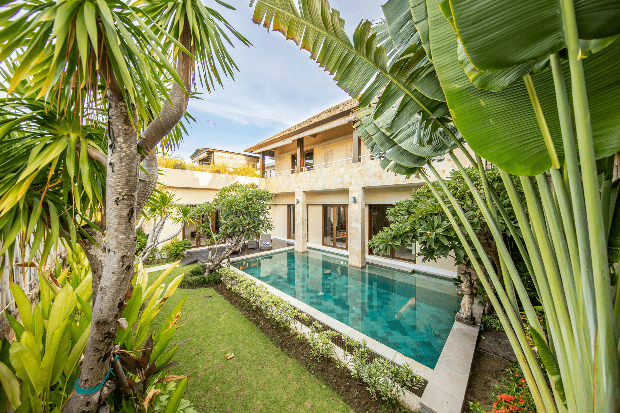This image shows an Indonesian villa with large garden area and pool.