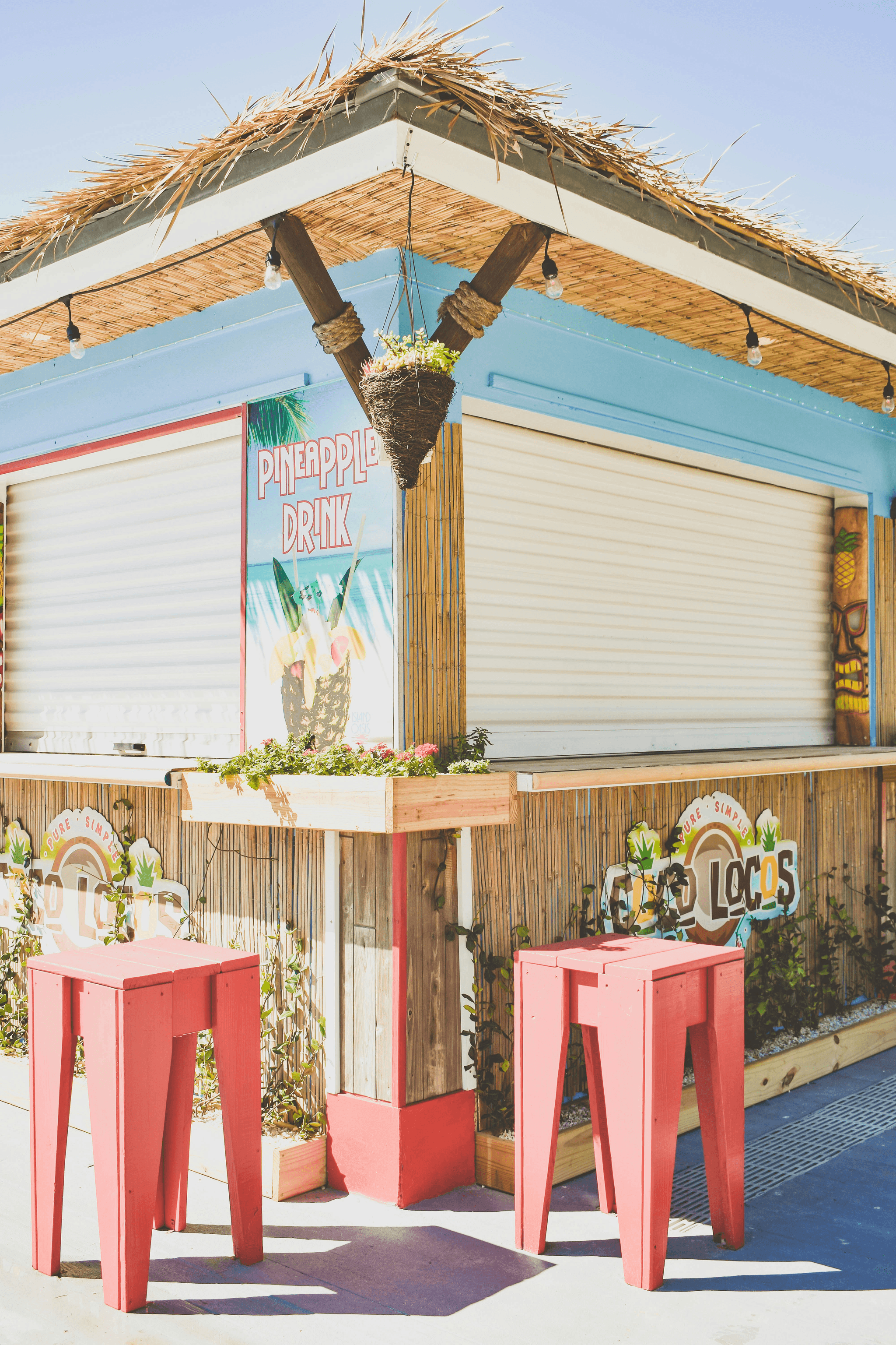 Charming outdoor scene with people enjoying drinks at a shipping container bar.
