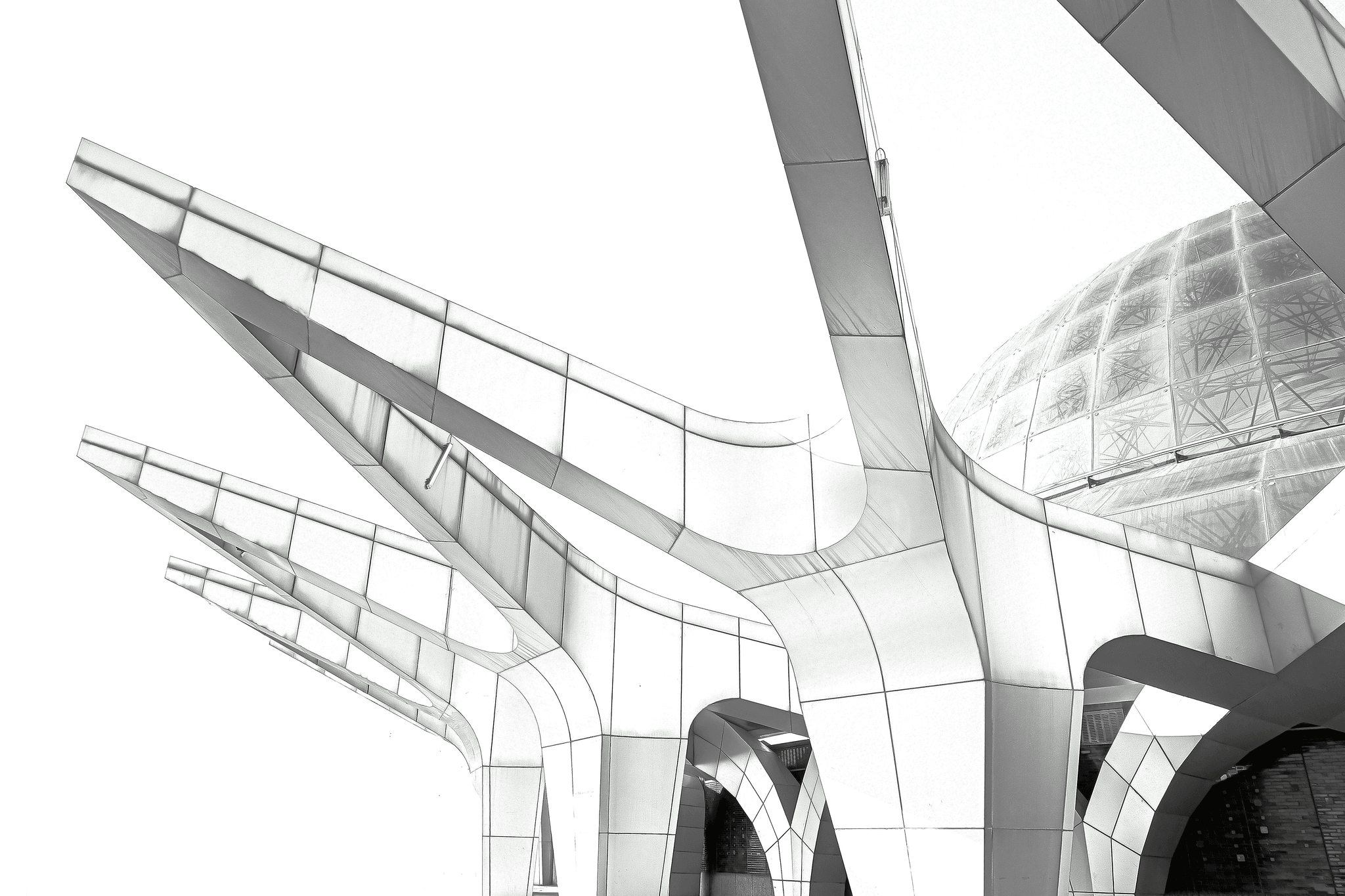 Architect sketching modern building design on digital tablet surrounded by blueprints - Building Lovers