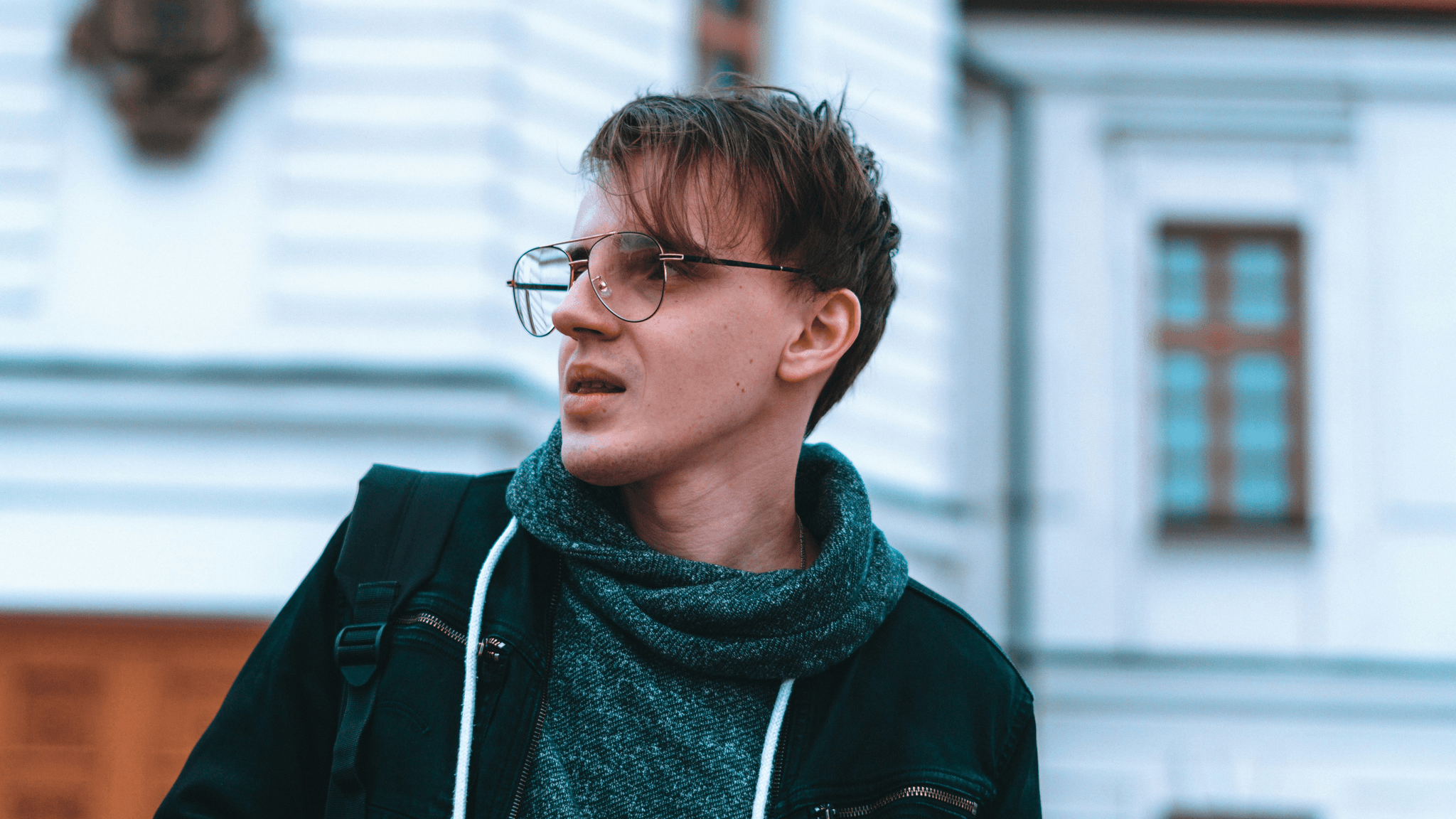 Stylish ai enhanced glasses worn by individual against urban backdrop.