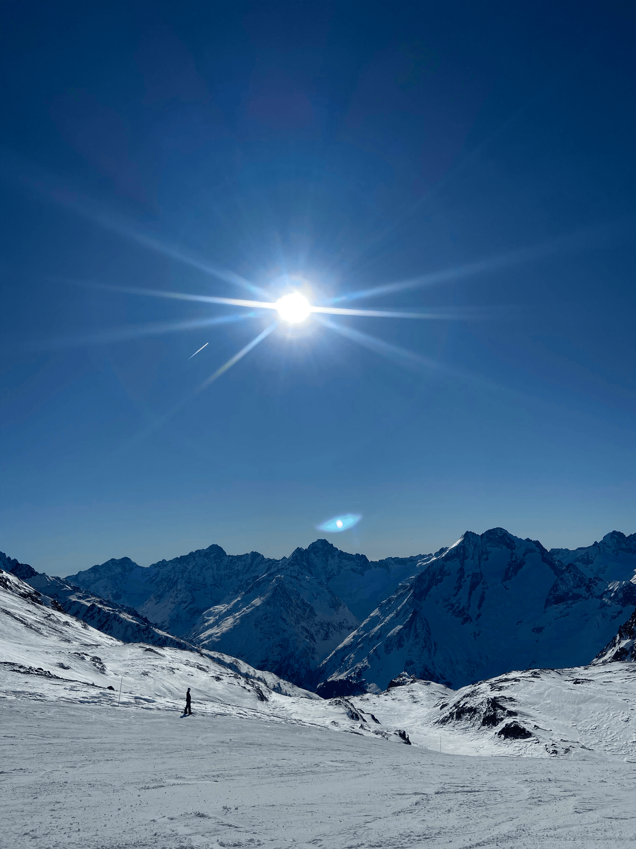 Stylish snow glasses worn by skiers on bright sunny slopes