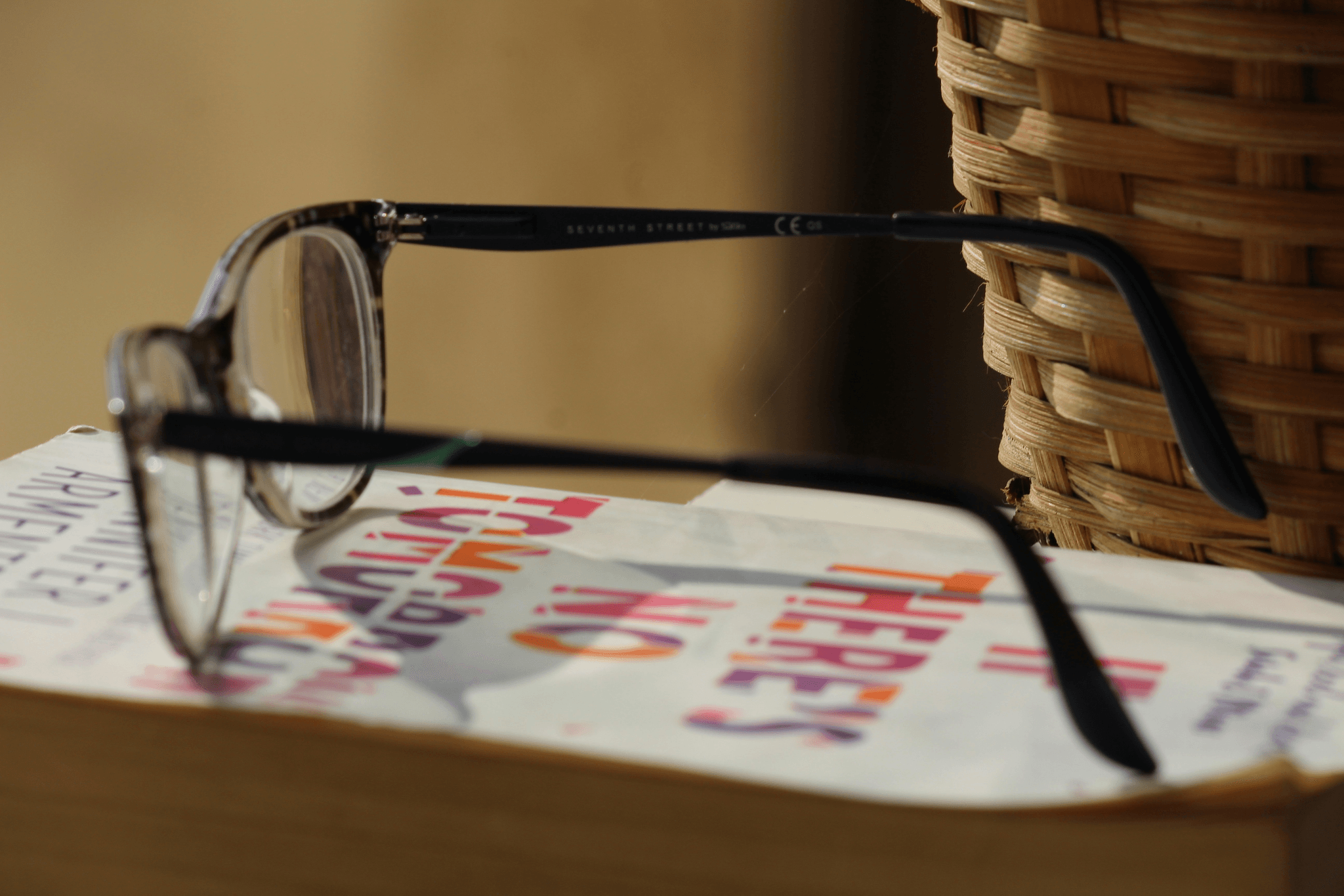 Stylish folding reading glasses with case showcased on a table.
