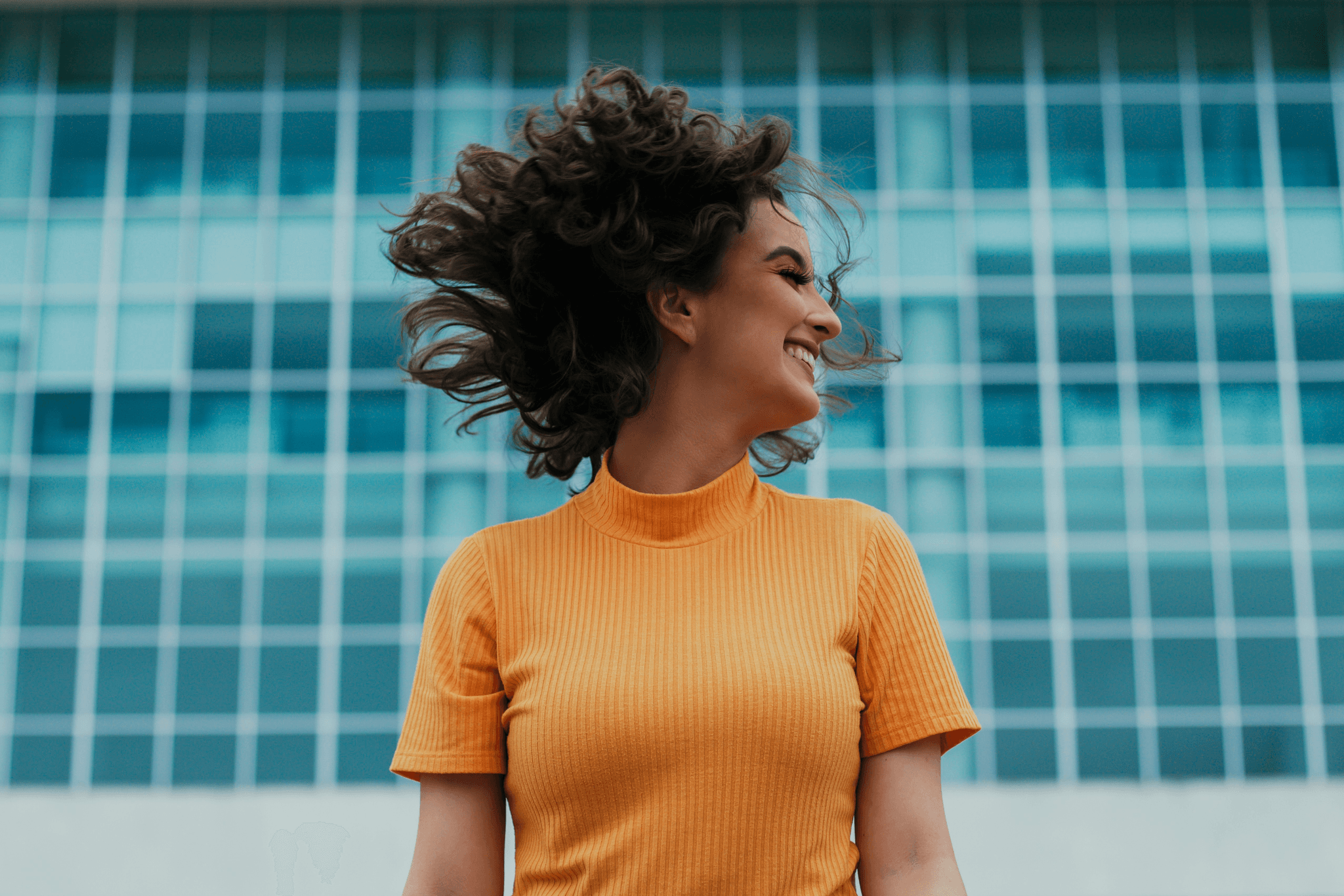 stunning woman flaunting her raw curly hair bundles