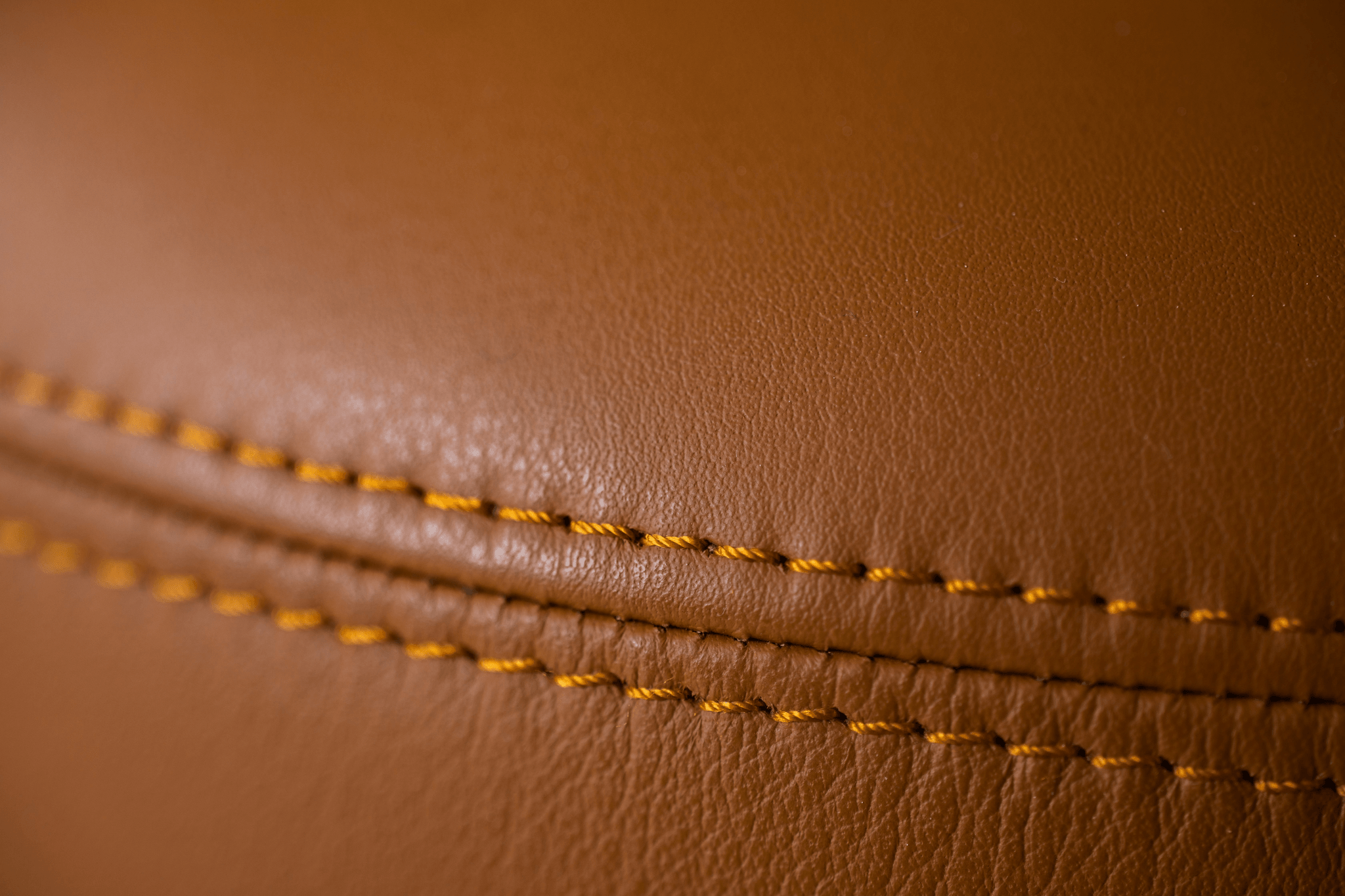 Leather bag inspection showing seam strength testing process.
