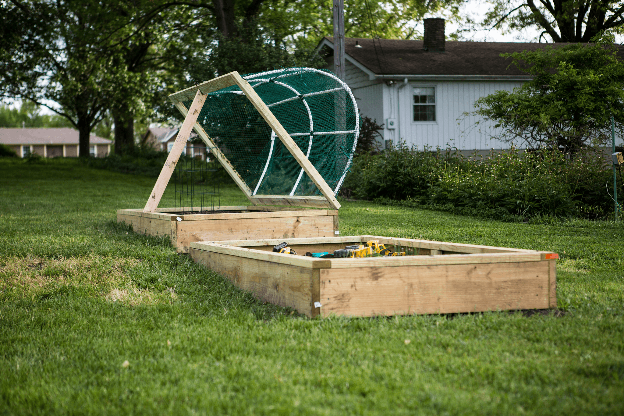 Beautiful view of decking in the garden with raised garden bed.