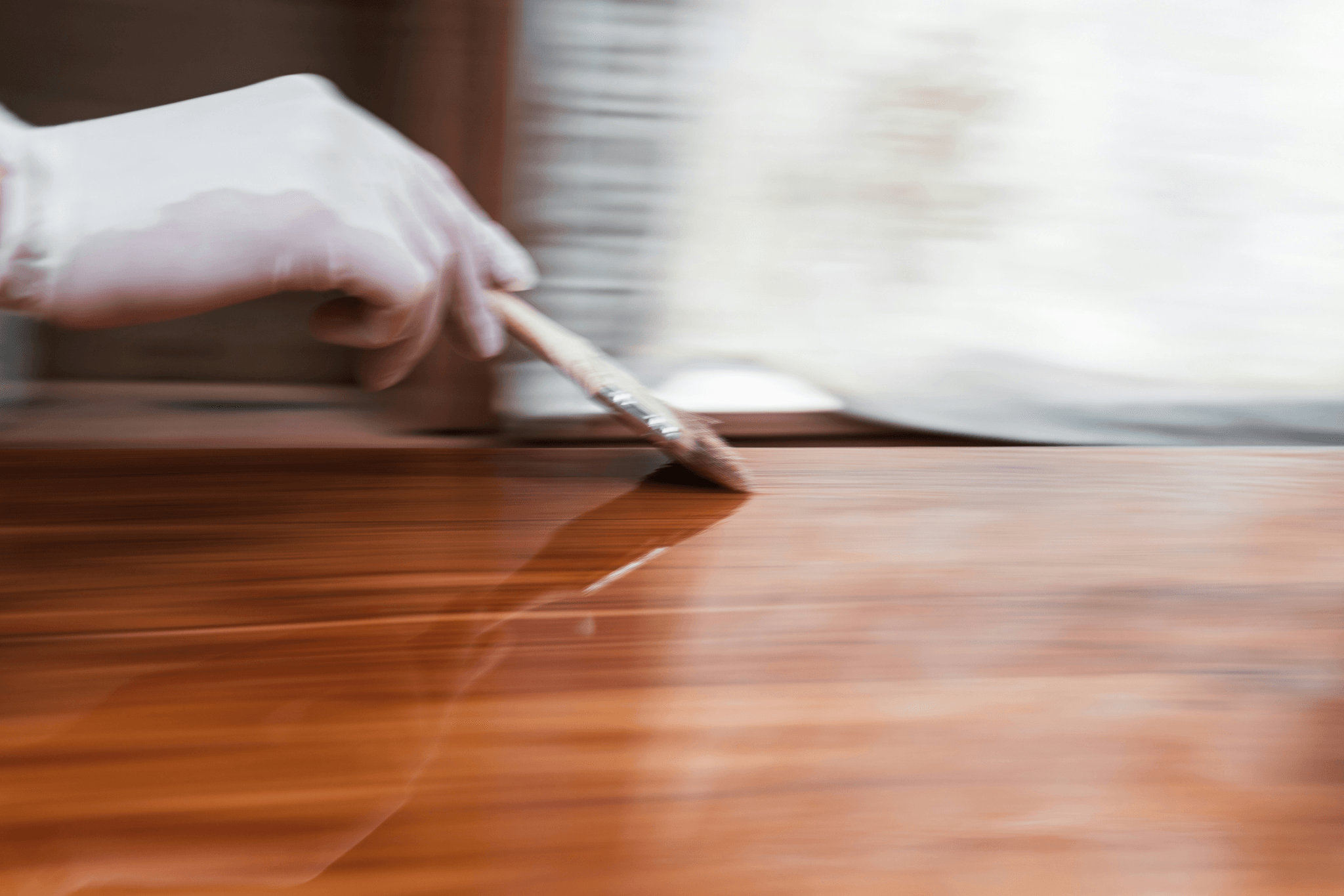 Applying eco friendly polyurethane sealer to wooden flooring