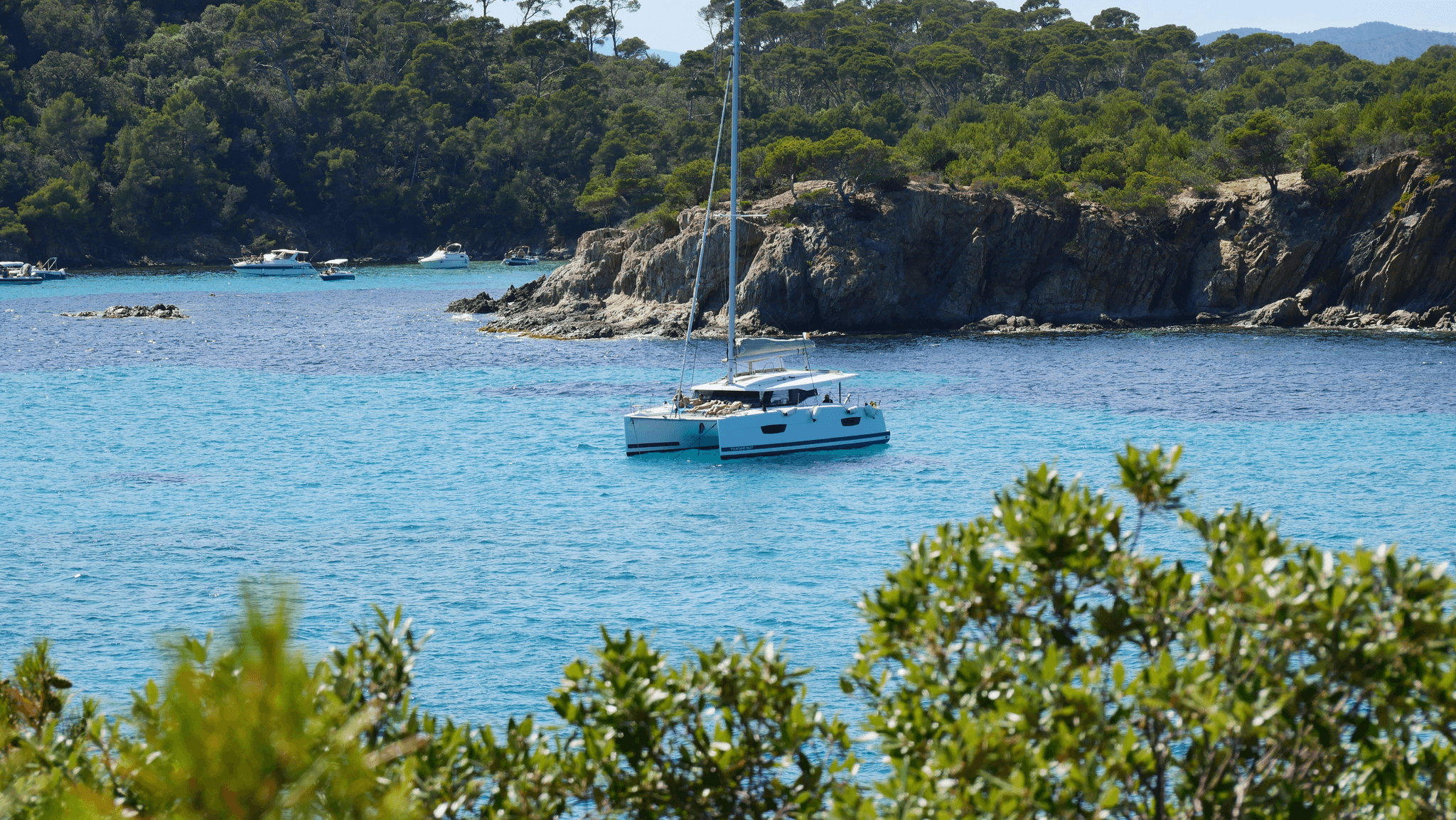 Luxury-Lagoon-Catamaran sailing through crystal-clear waters