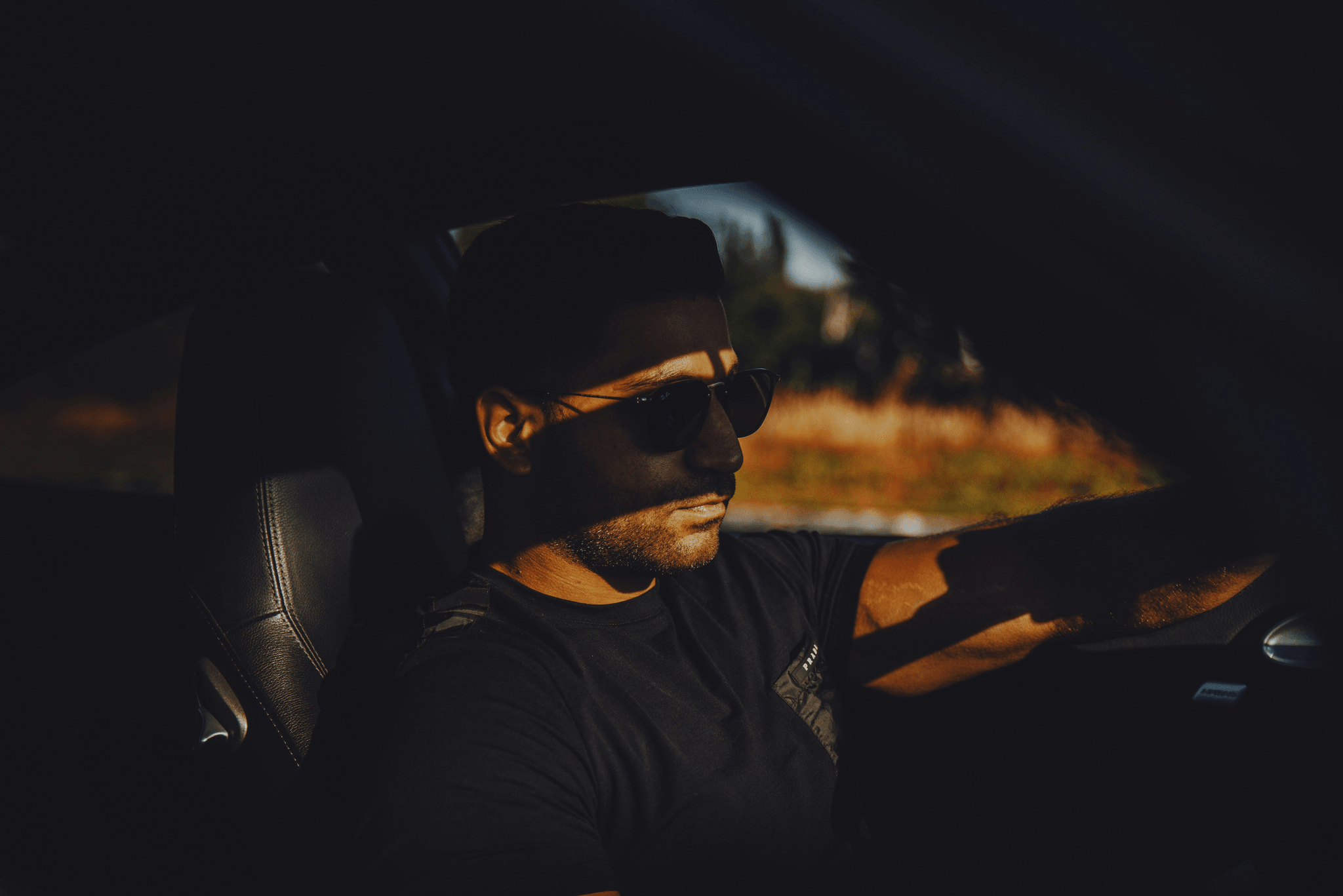 Stylish driver using polarized sunglasses for driving