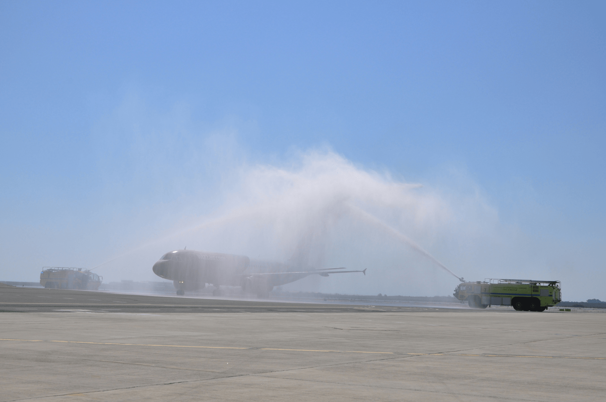 Aircraft fuel truck at work during airplane refueling process.