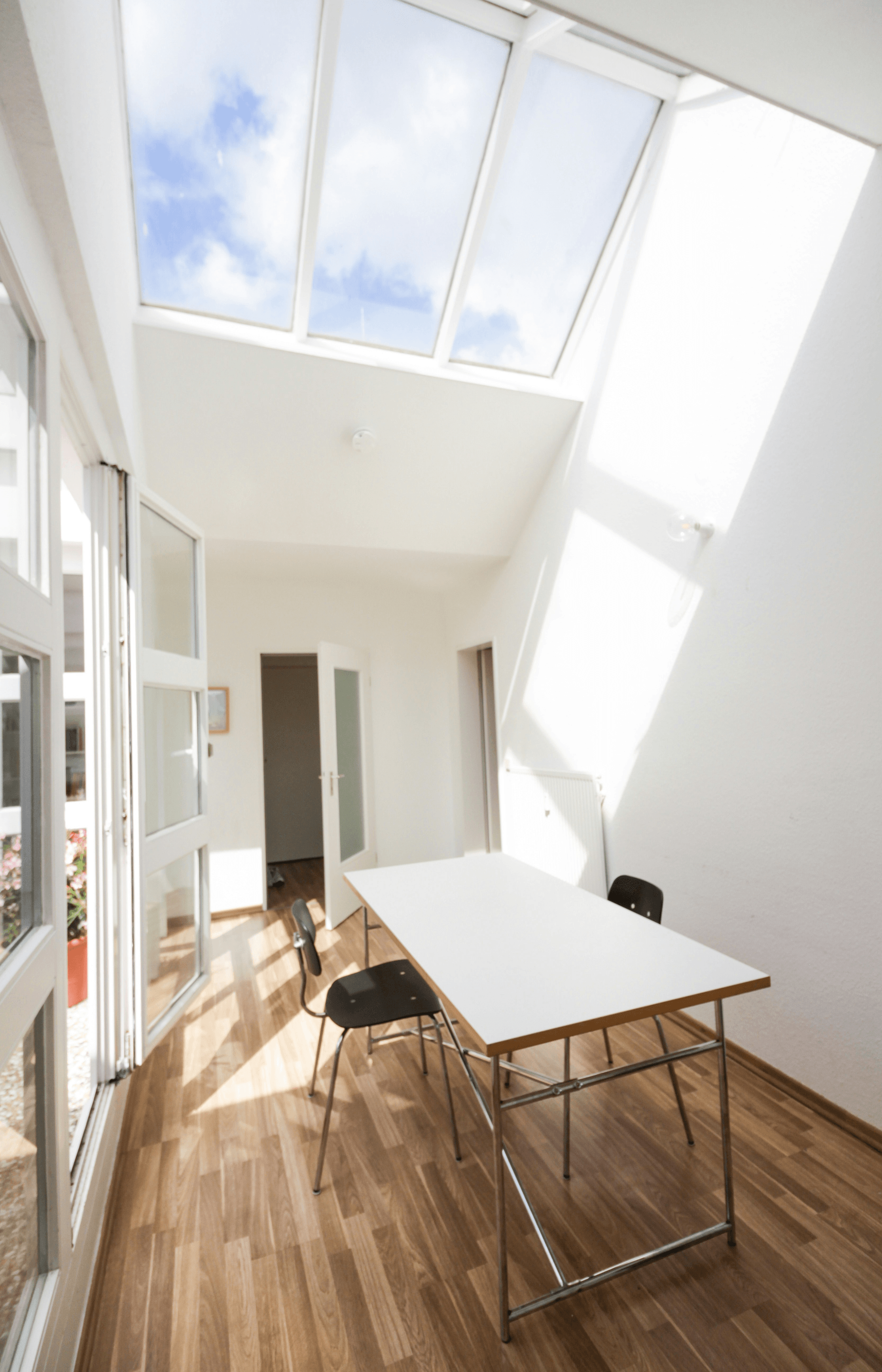 Naturally lit sunroom with skylights in prefab house