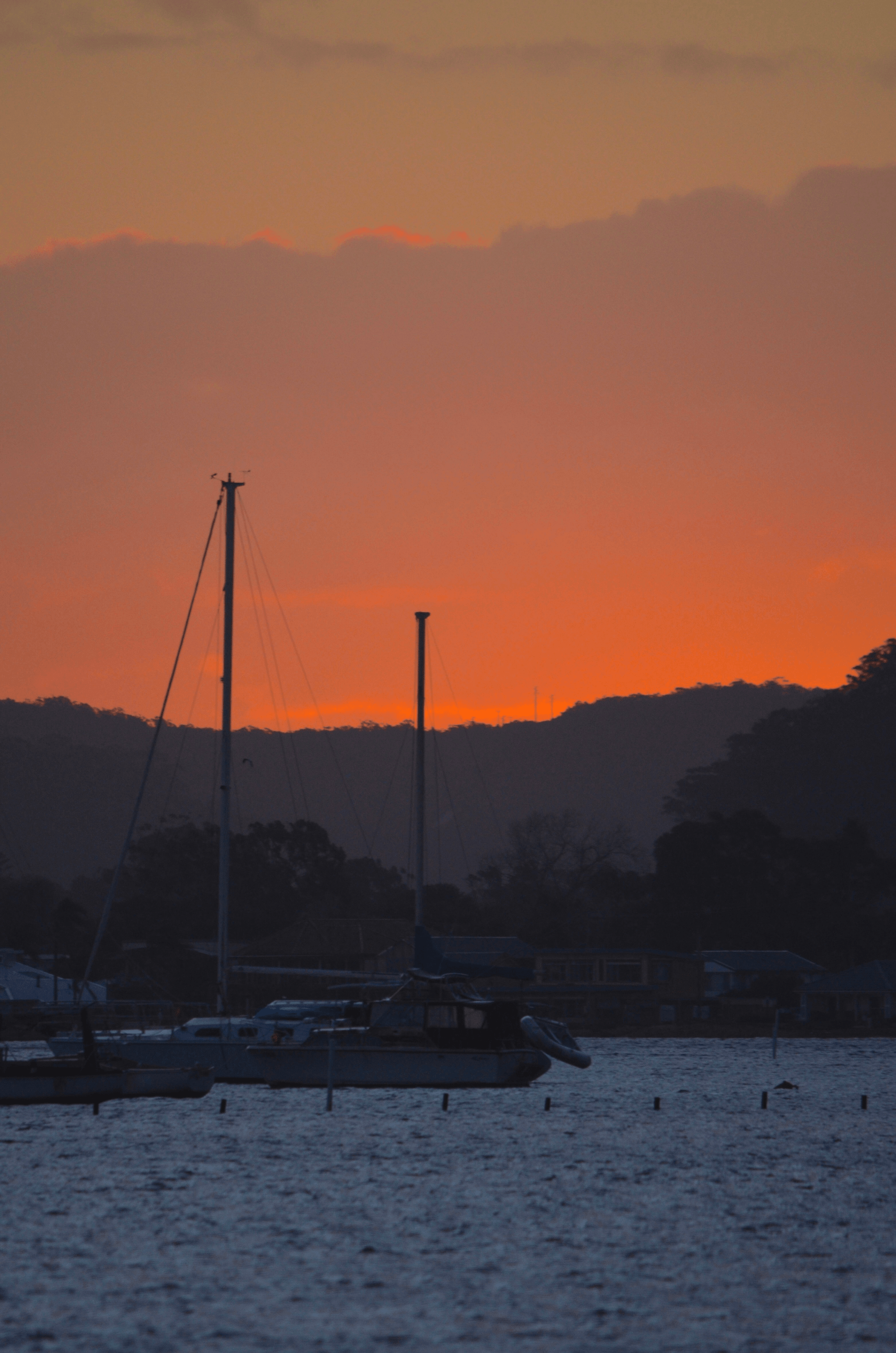 Small Aluminum Boat Sailing on Calm Waters at Sunset