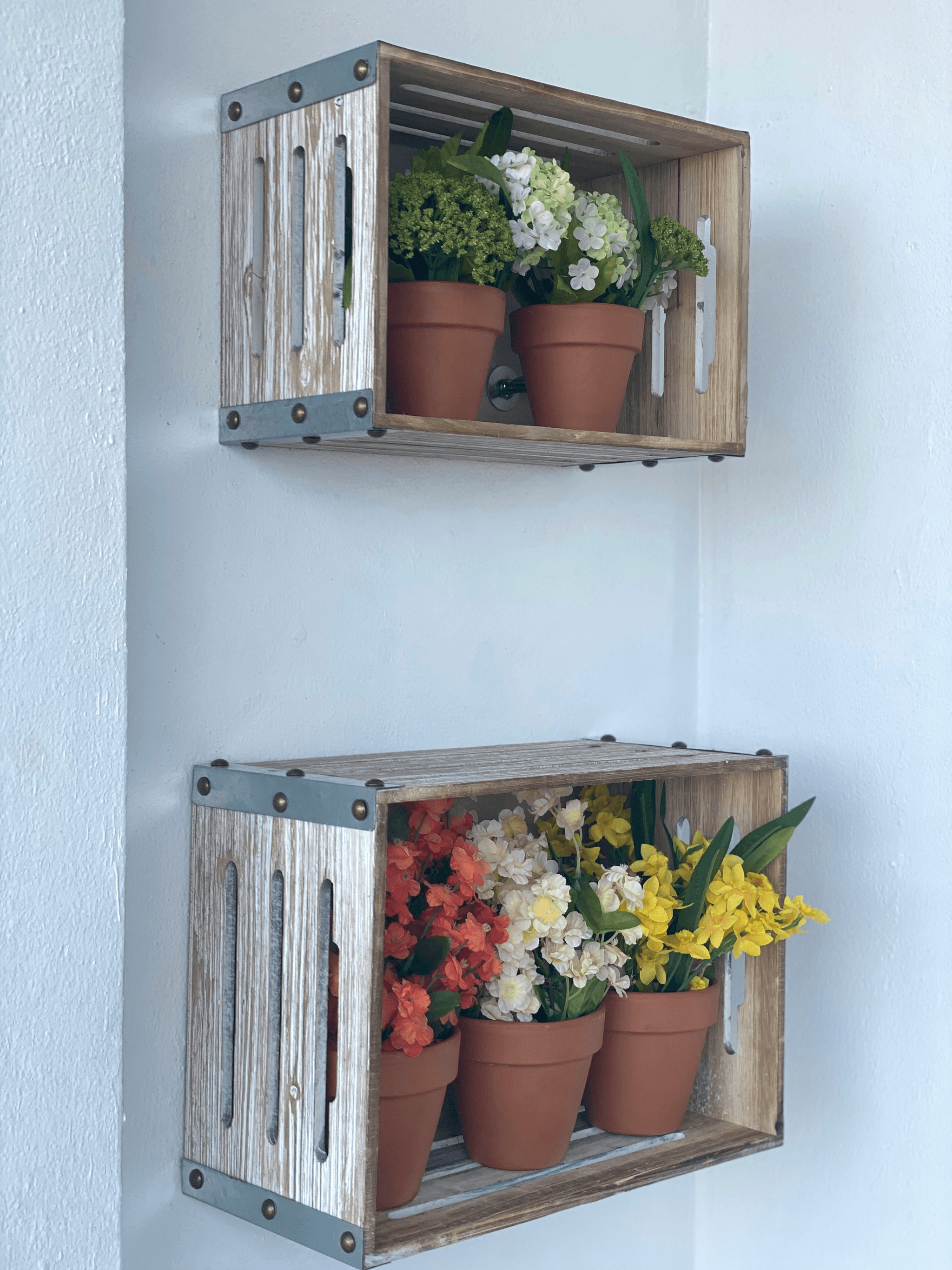 home decorate DIY project using upcycled wooden crates as shelves with potted plants.