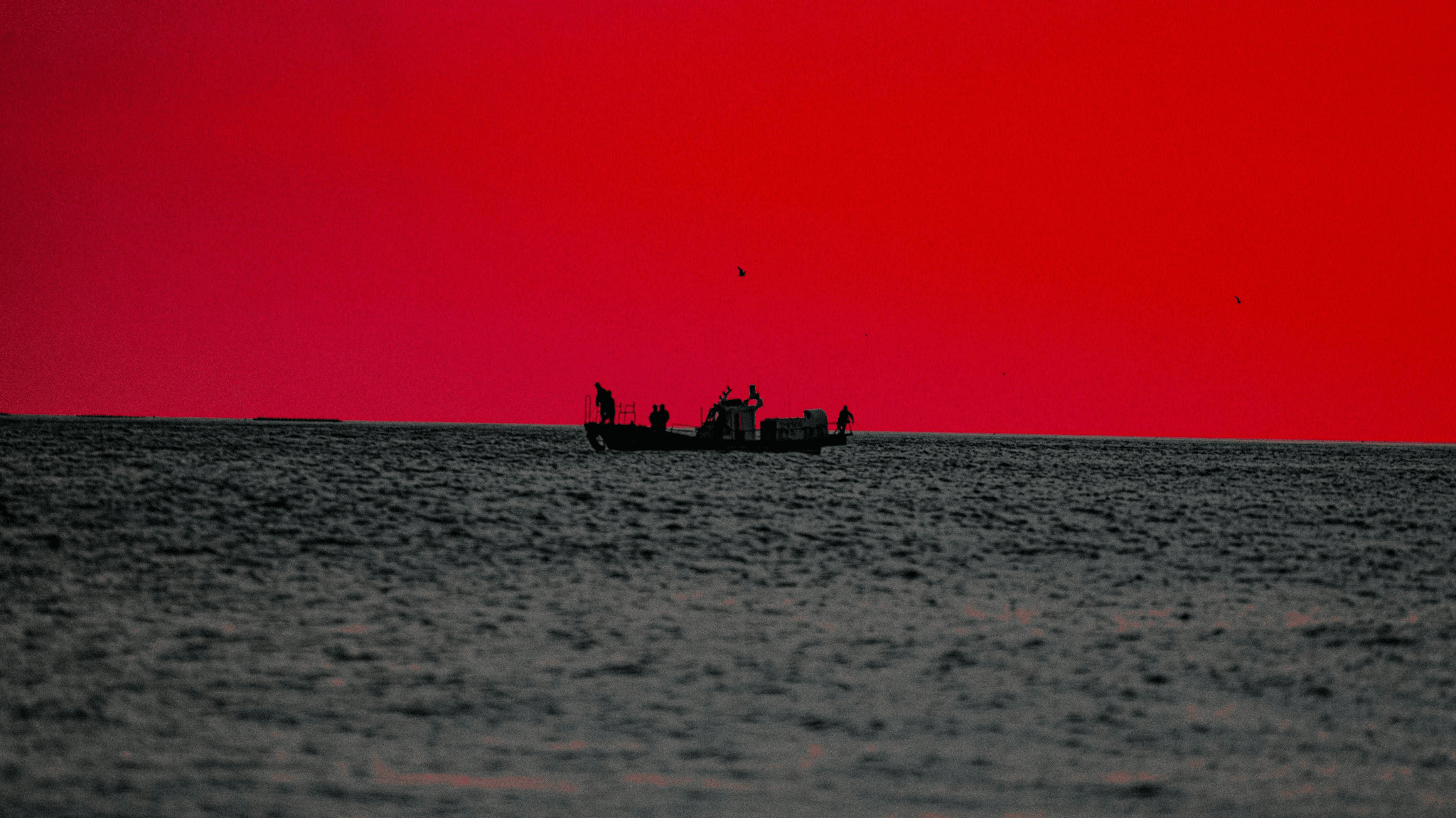 A sleek aluminum fishing boat gliding through calm waters showcasing fuel efficiency.