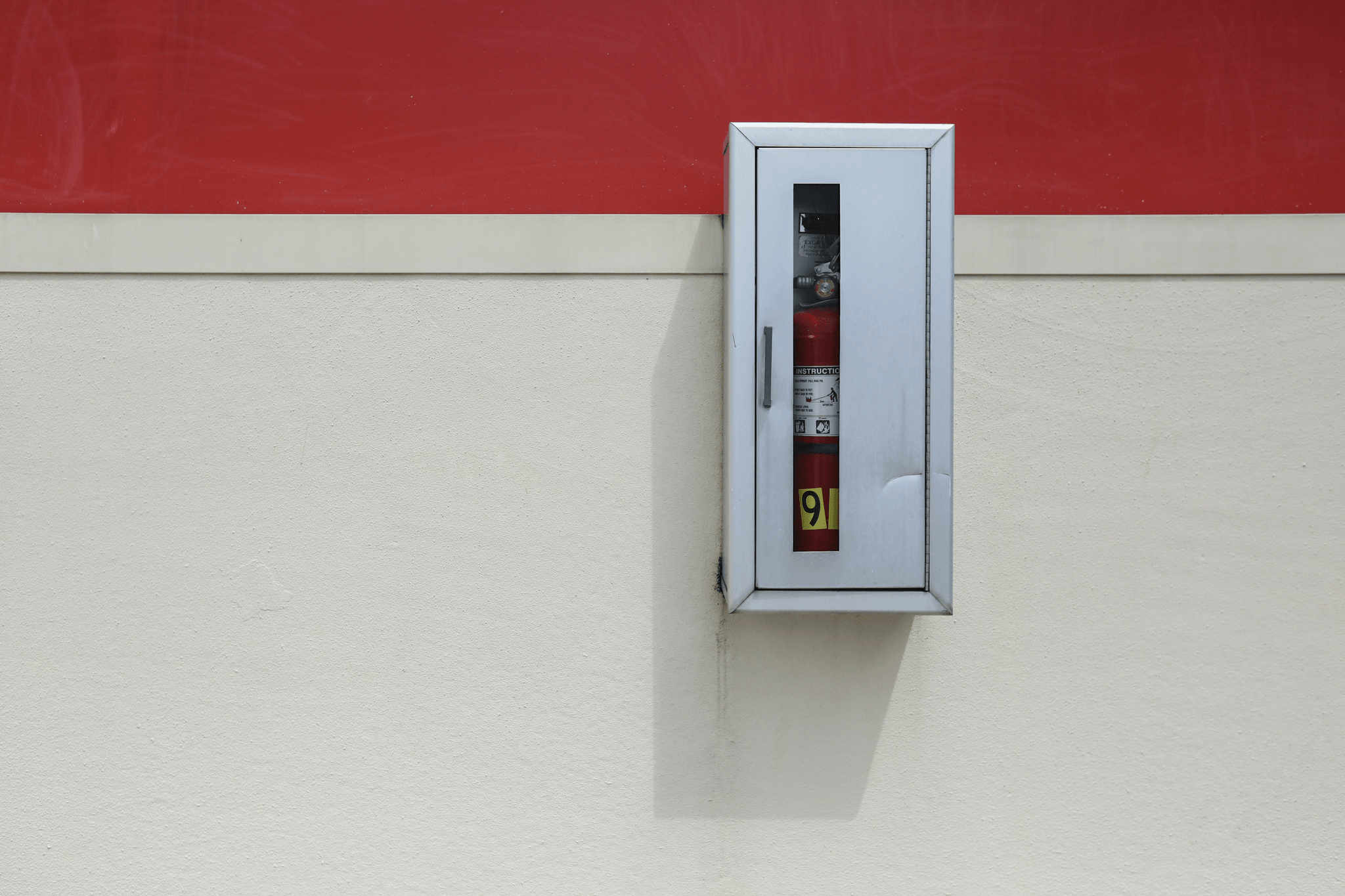 Visual check of fire extinguisher pressure and labels.