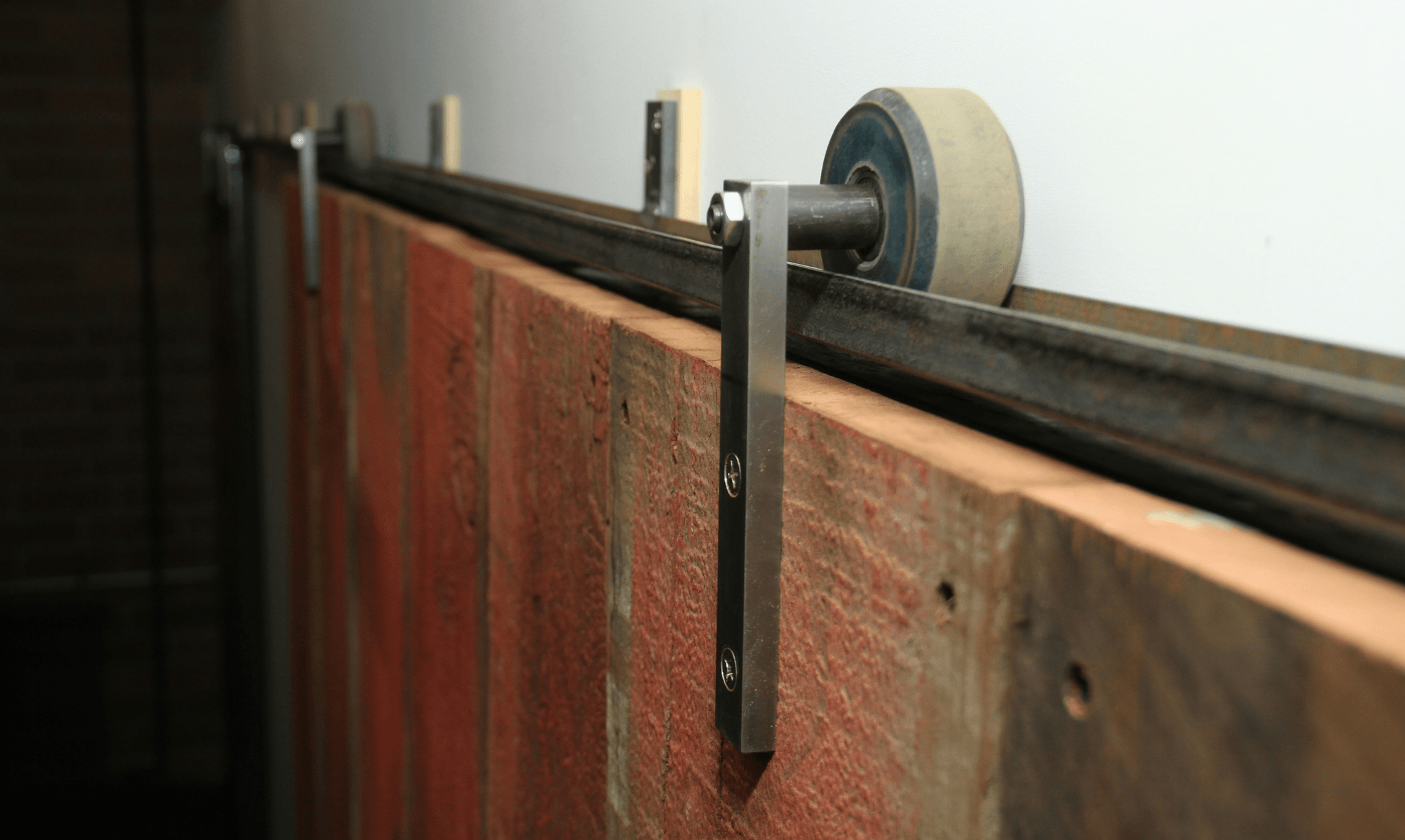 Attaching metal track for smooth movement of mirror closet sliding doors