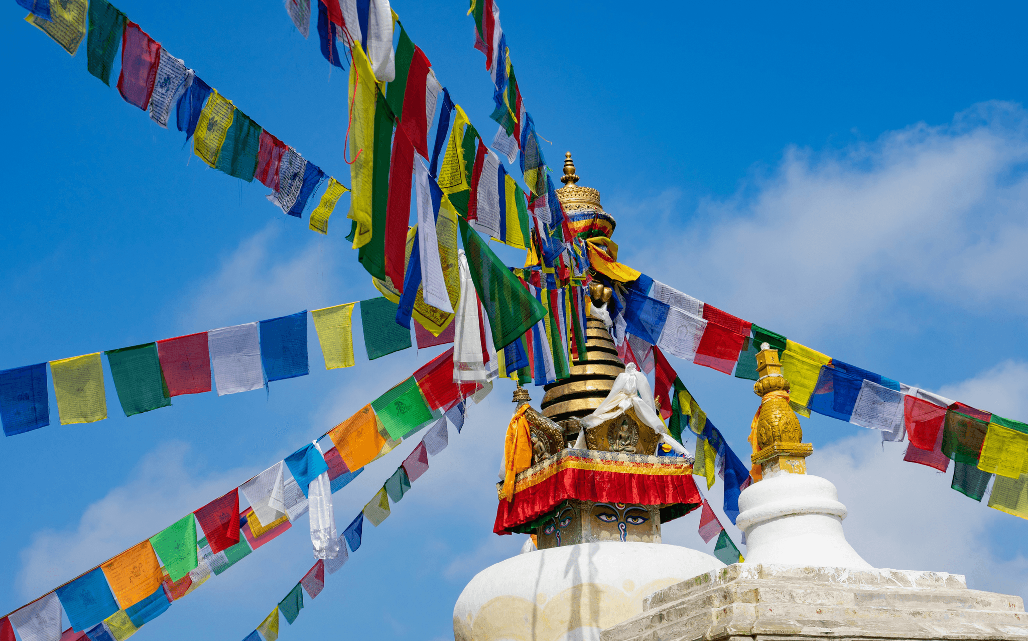 Holy Tibetan Stupa surrounded by vibrant prayer flags.
