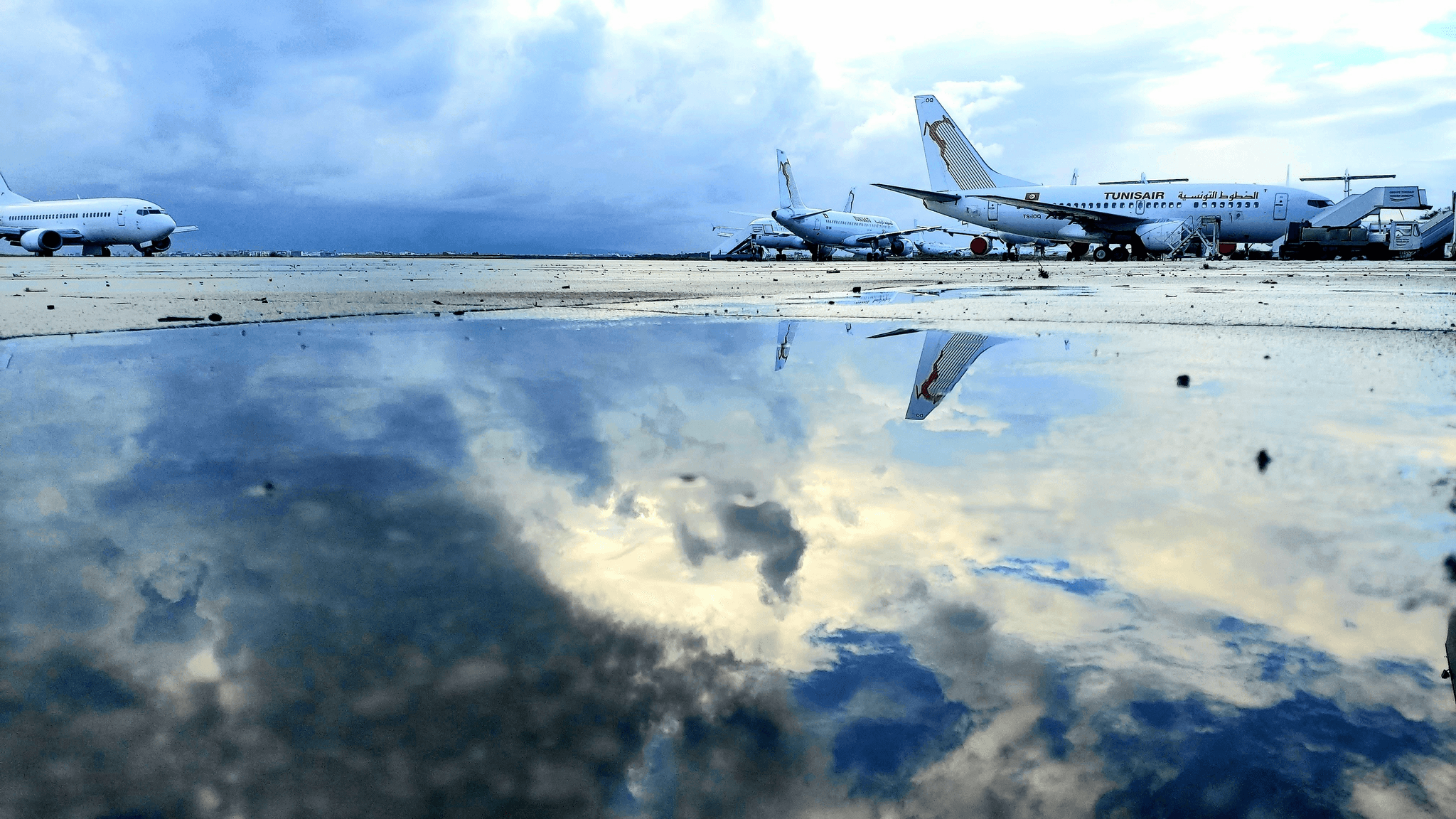 airplane fuel truck lining up near Boeing 747