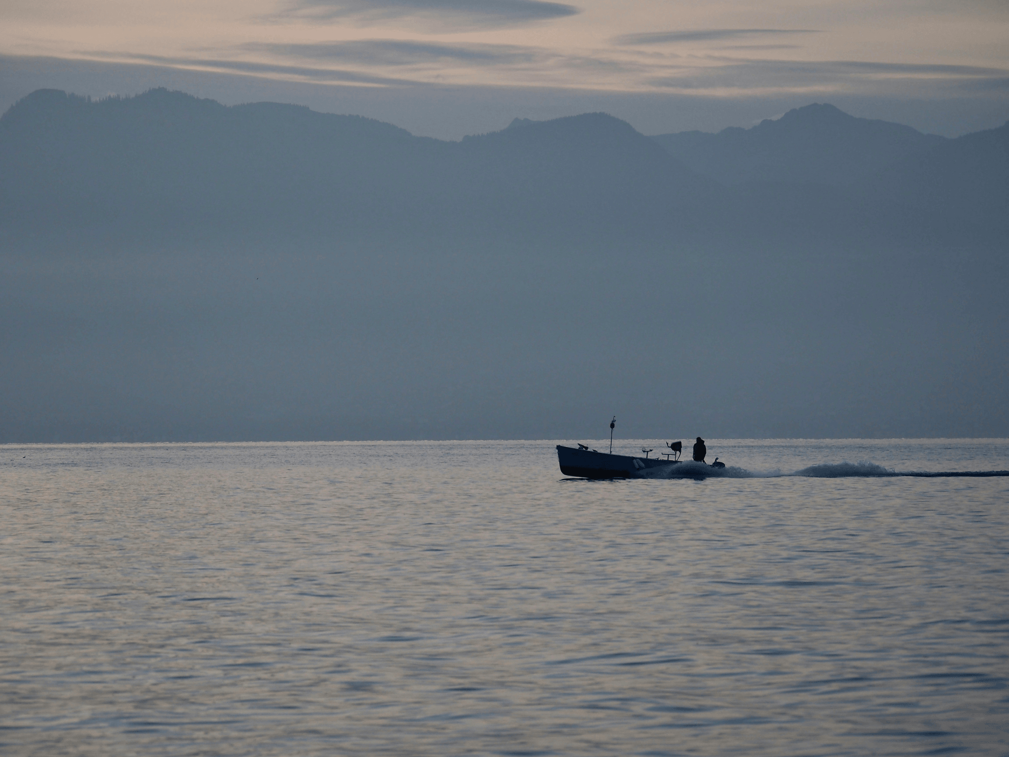 Aluminum Utility Boat Cruising Through Calm Waters