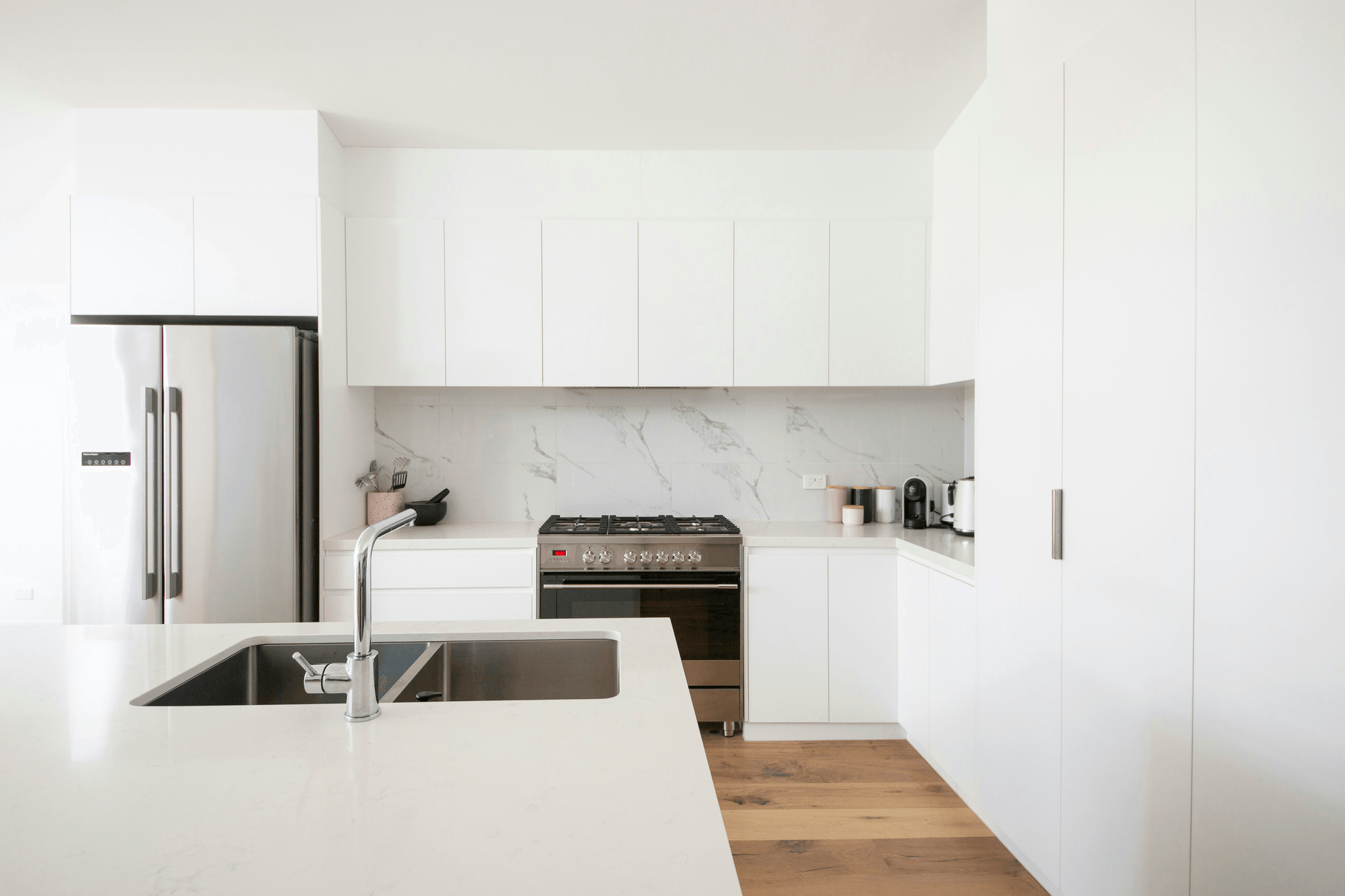 Sleek white sintered stone countertop in modern kitchen