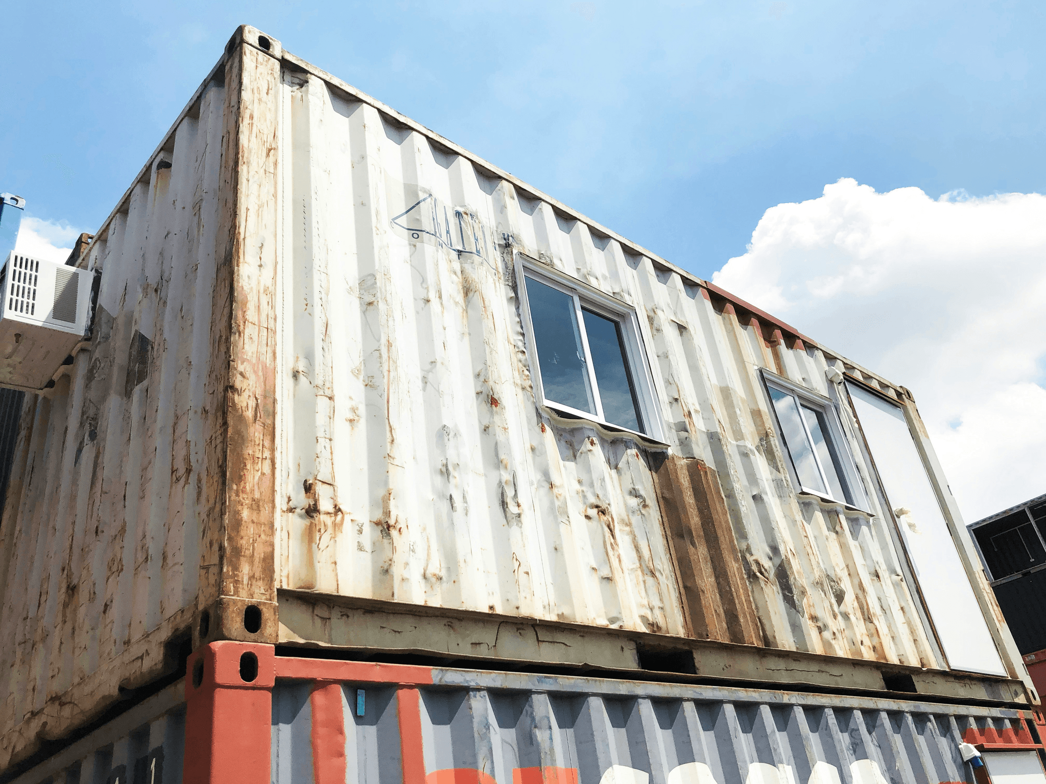 Weather-resistant portable house container with durable construction materials