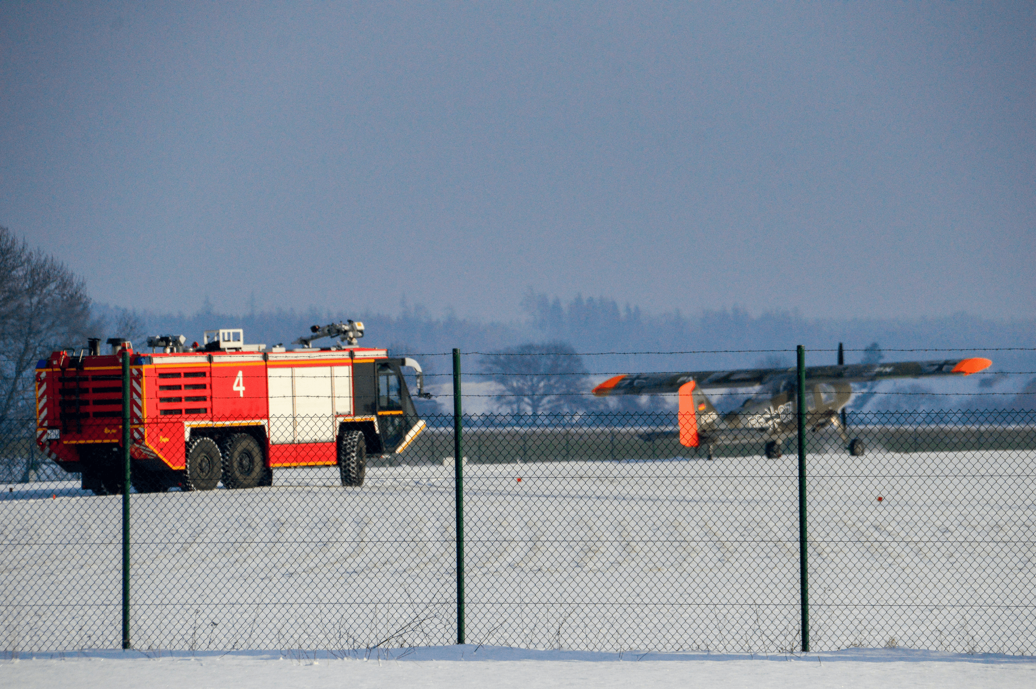 snow blower truck clearing runway at busy airport