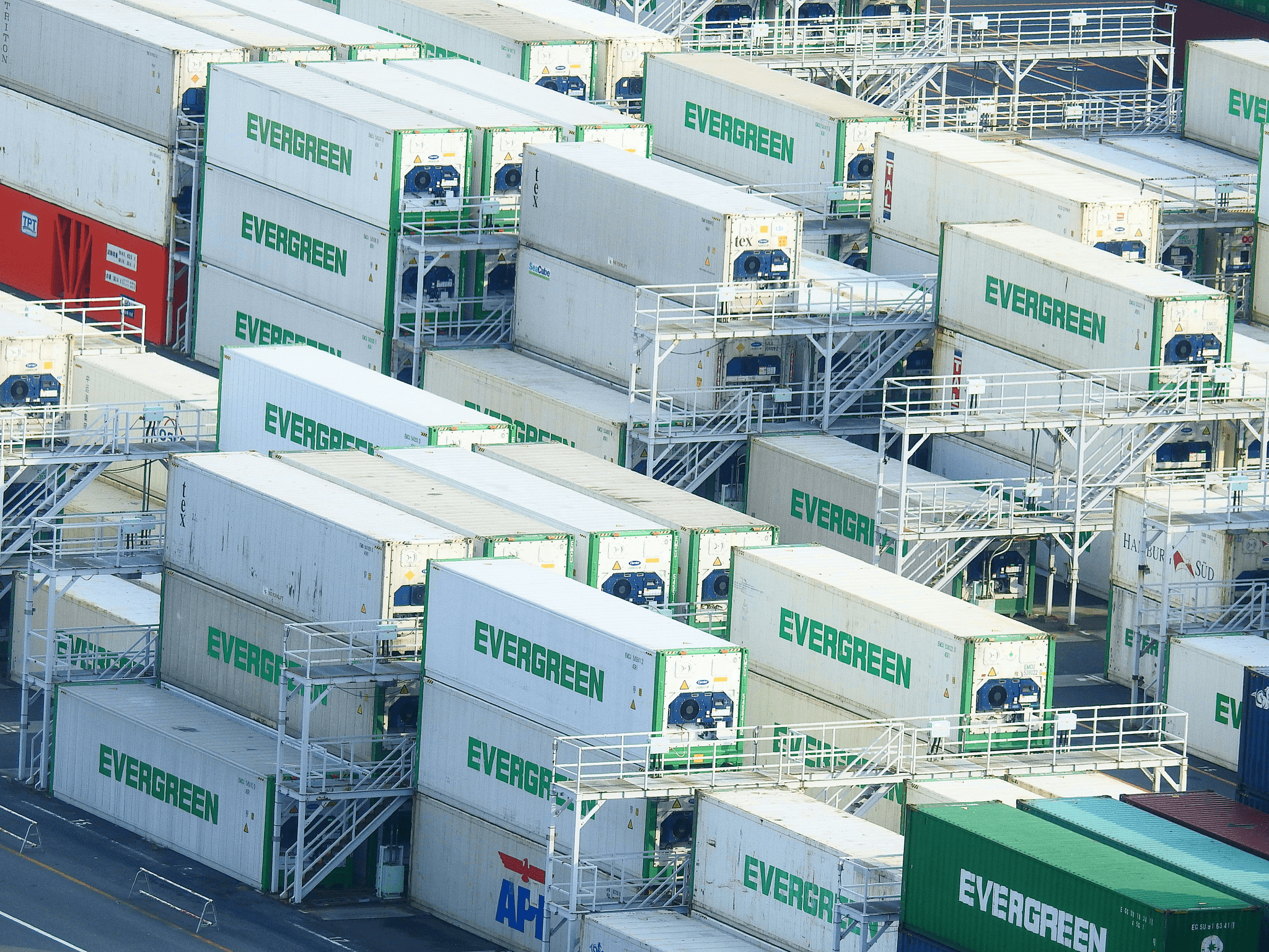 Neatly stacked 20ft shipping containers in storage yard