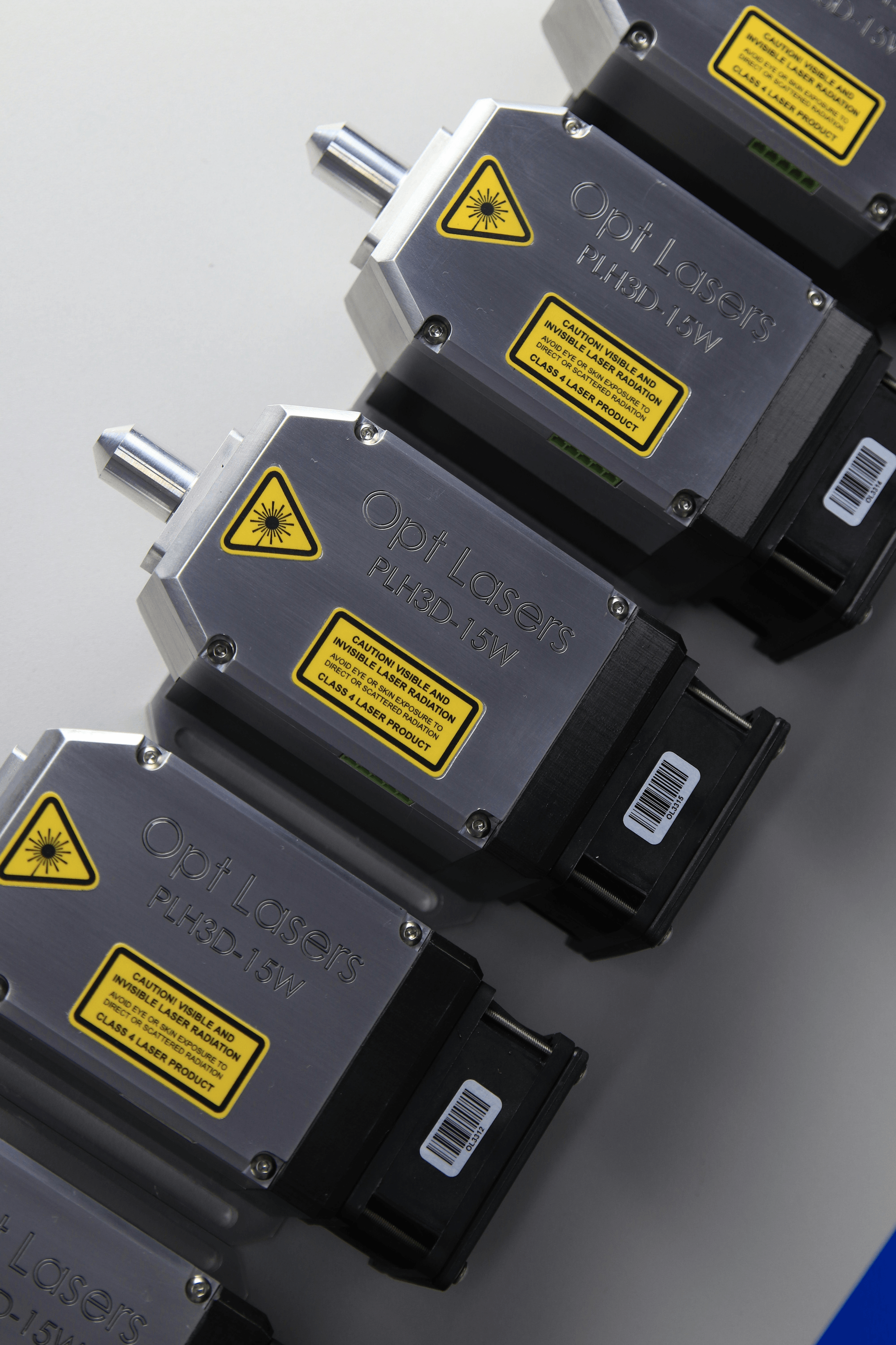 Various electronic actuators displayed on a workshop table.