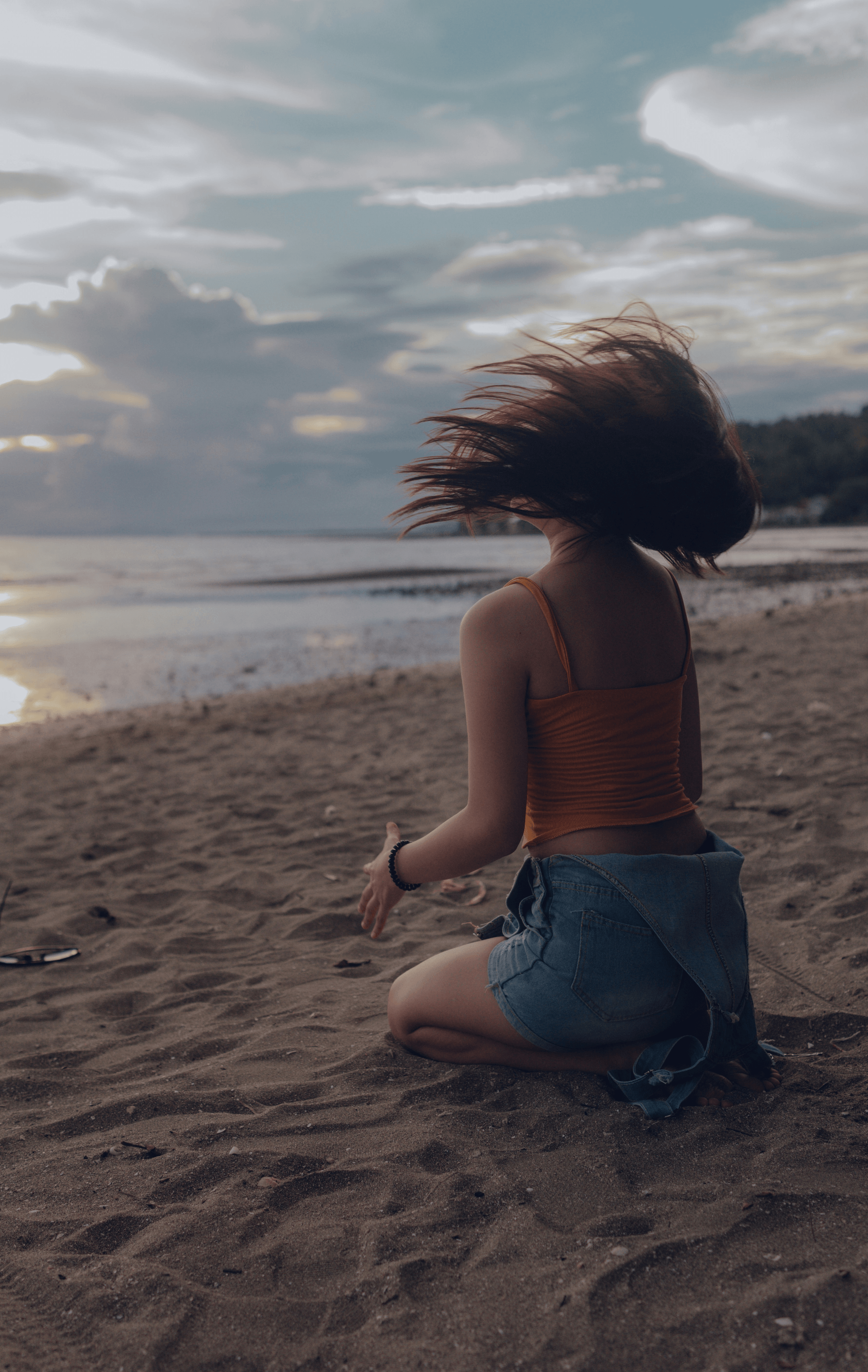 Beach setting with wig care products and accessories.